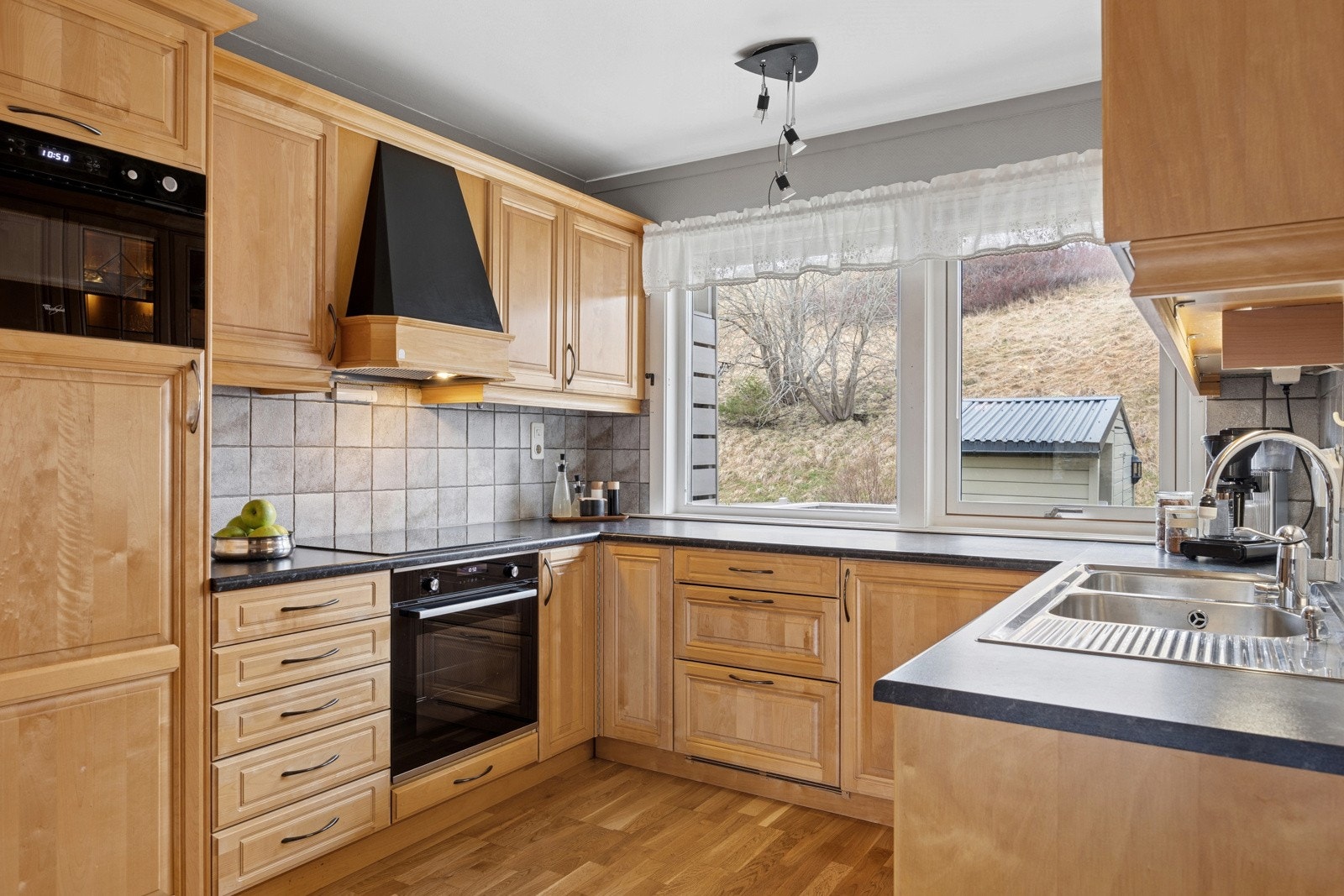 Kjøkkenet er av romslig karakter med svært god oppbevaringsplass i skuffer og skap. Klassisk innredning med profilerte fronter og medfølgende hvitevarer i form av platetopp, stekeovn, mikroovn, oppvaskmaskin og kjøleskap. Galleribilde