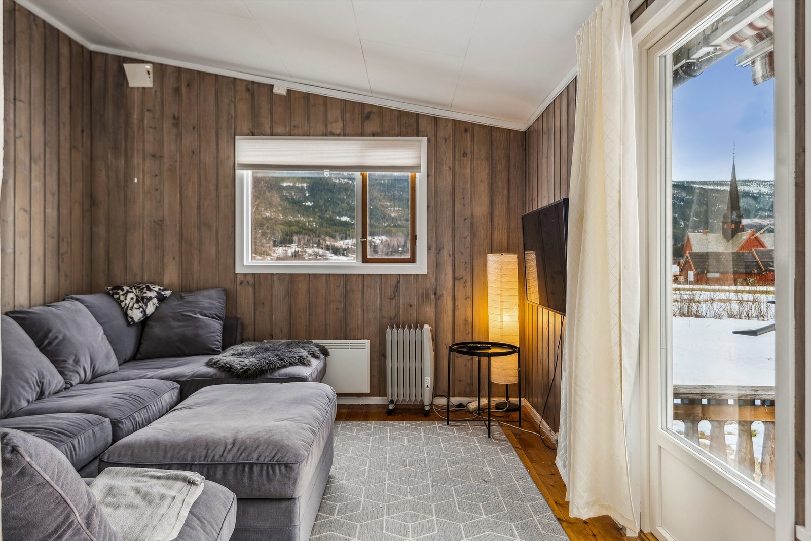 TV-stuen har utgang til en lun uteplass med utsikt mot kirken og Lomnessjøen. Galleribilde