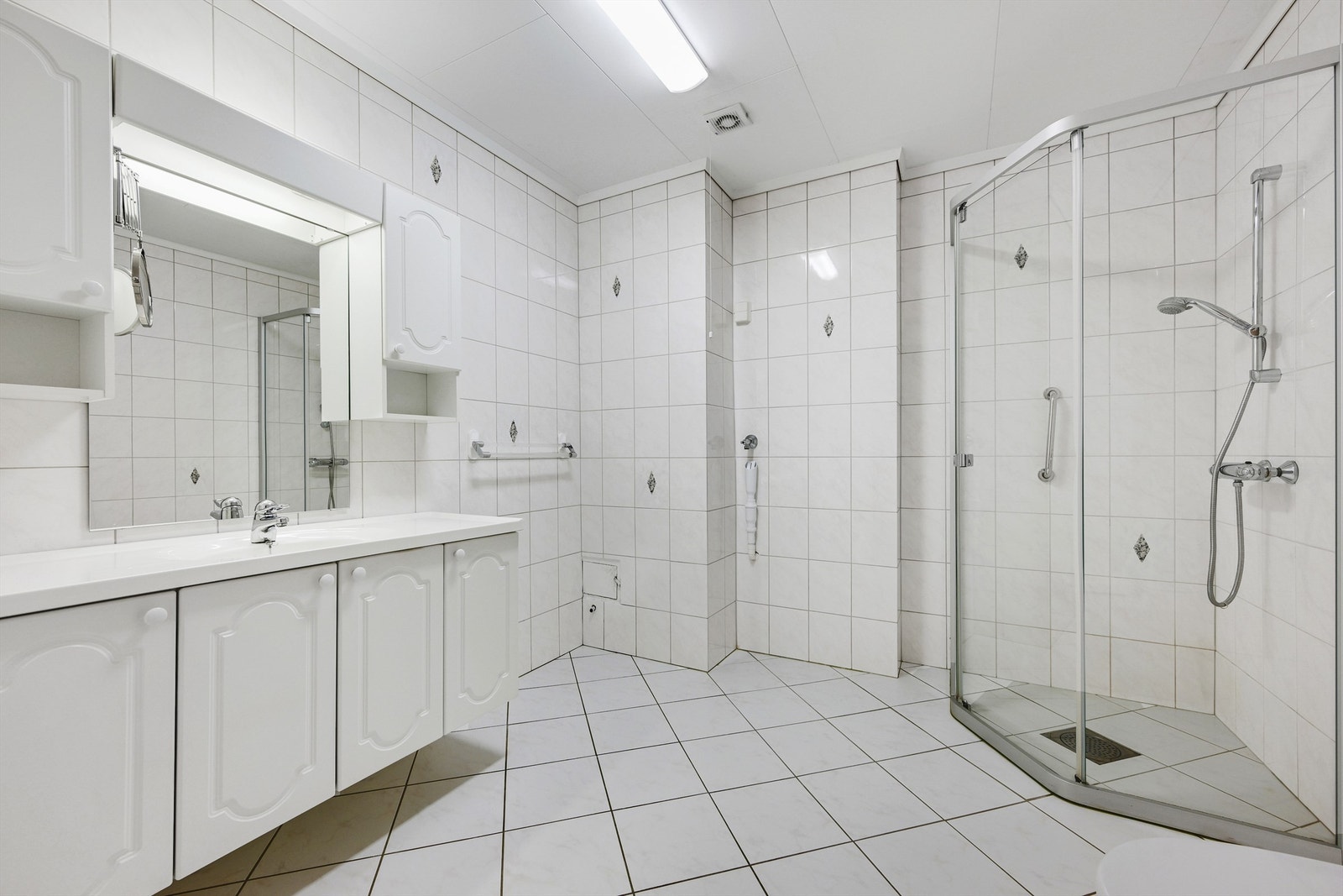 Badet er lyst og har flislagte vegger og gulv. Galleribilde