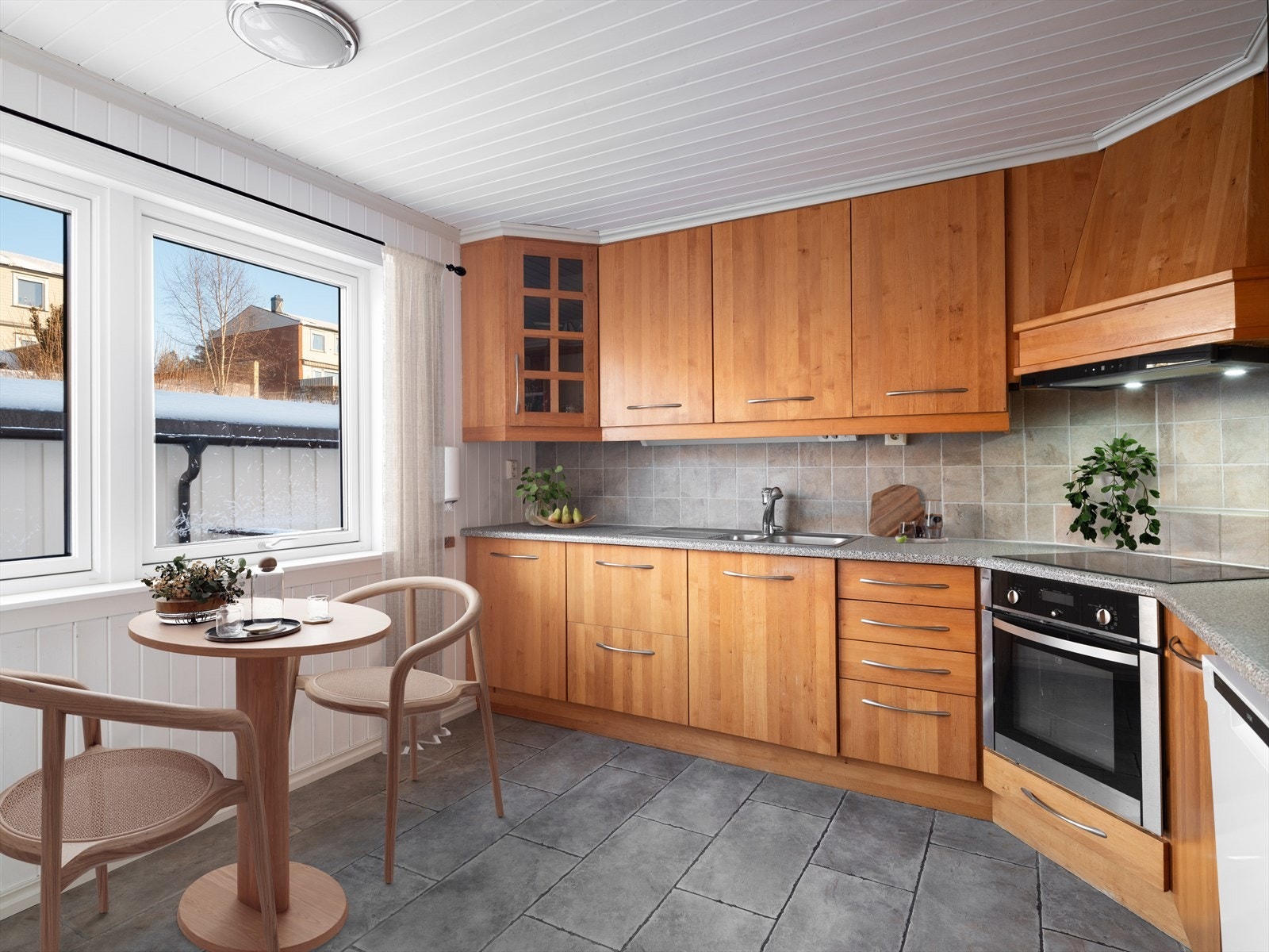 Koselig kjøkken med plass til kjøkkenbord i forbindelse med vindu. Integrerte hvitevarer er kjøleskap, platetopp og stekeovn. (Bildet har digital møblering, og er kun en illustrasjon) Galleribilde