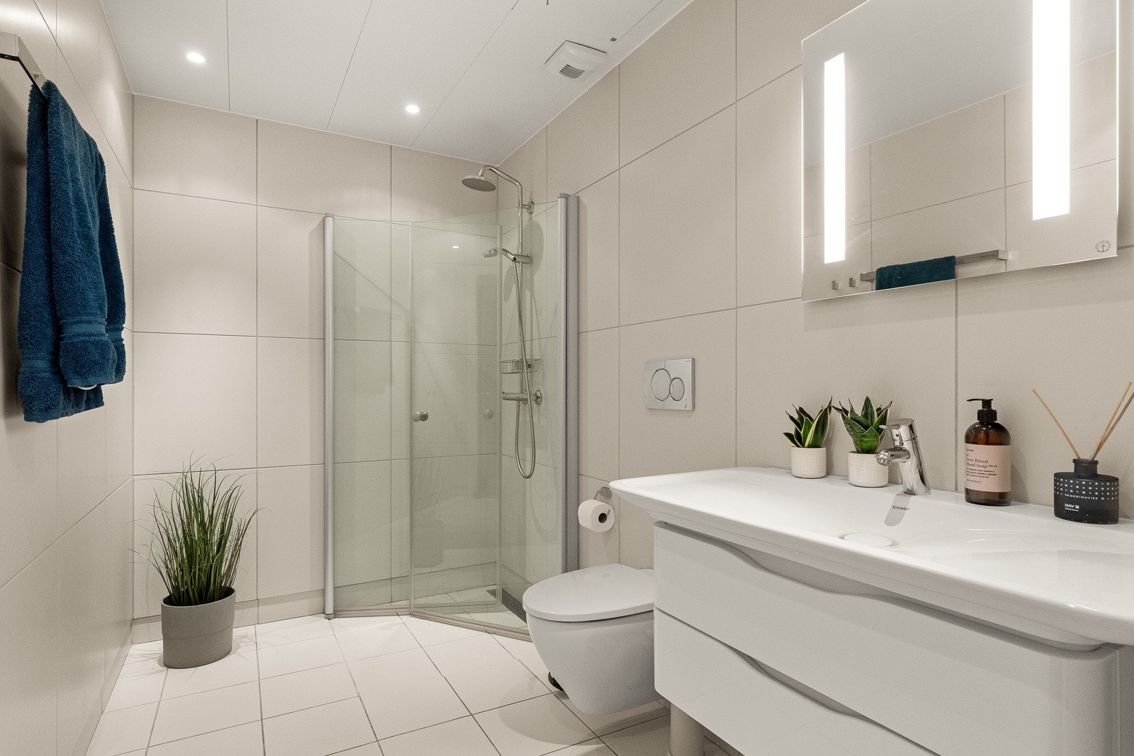 Innbydende flislagt baderom av god størrelse med praktisk tilgang via entréen/gangen. Galleribilde