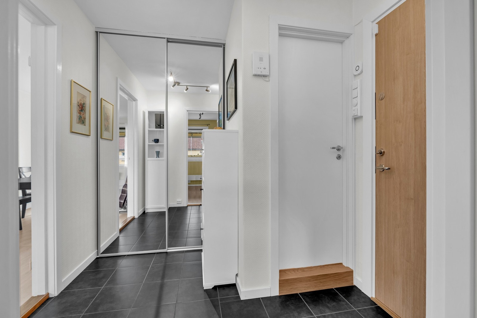 Flislagt entré med skyvedørsgarderobe. Galleribilde