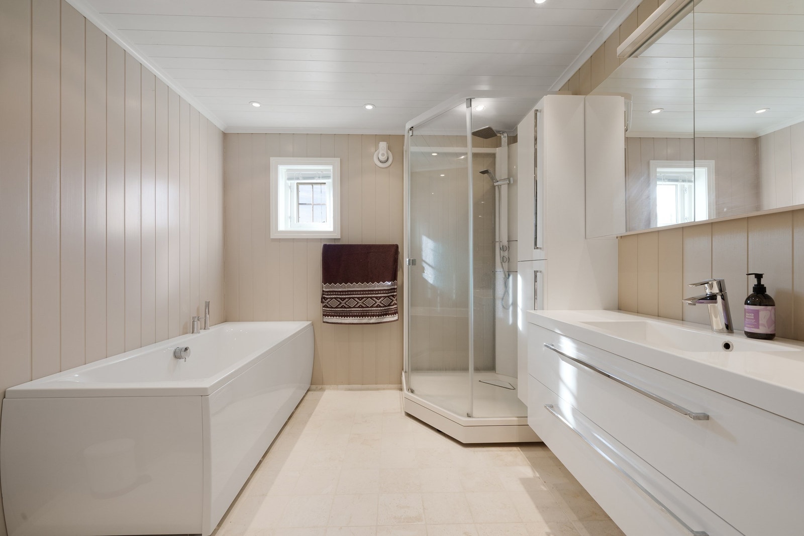 Badet i 1. etg. Innredet med vegghengt wc, servant med skuffer og overskap. Høyskap, dusjkabinett og badekar. Galleribilde