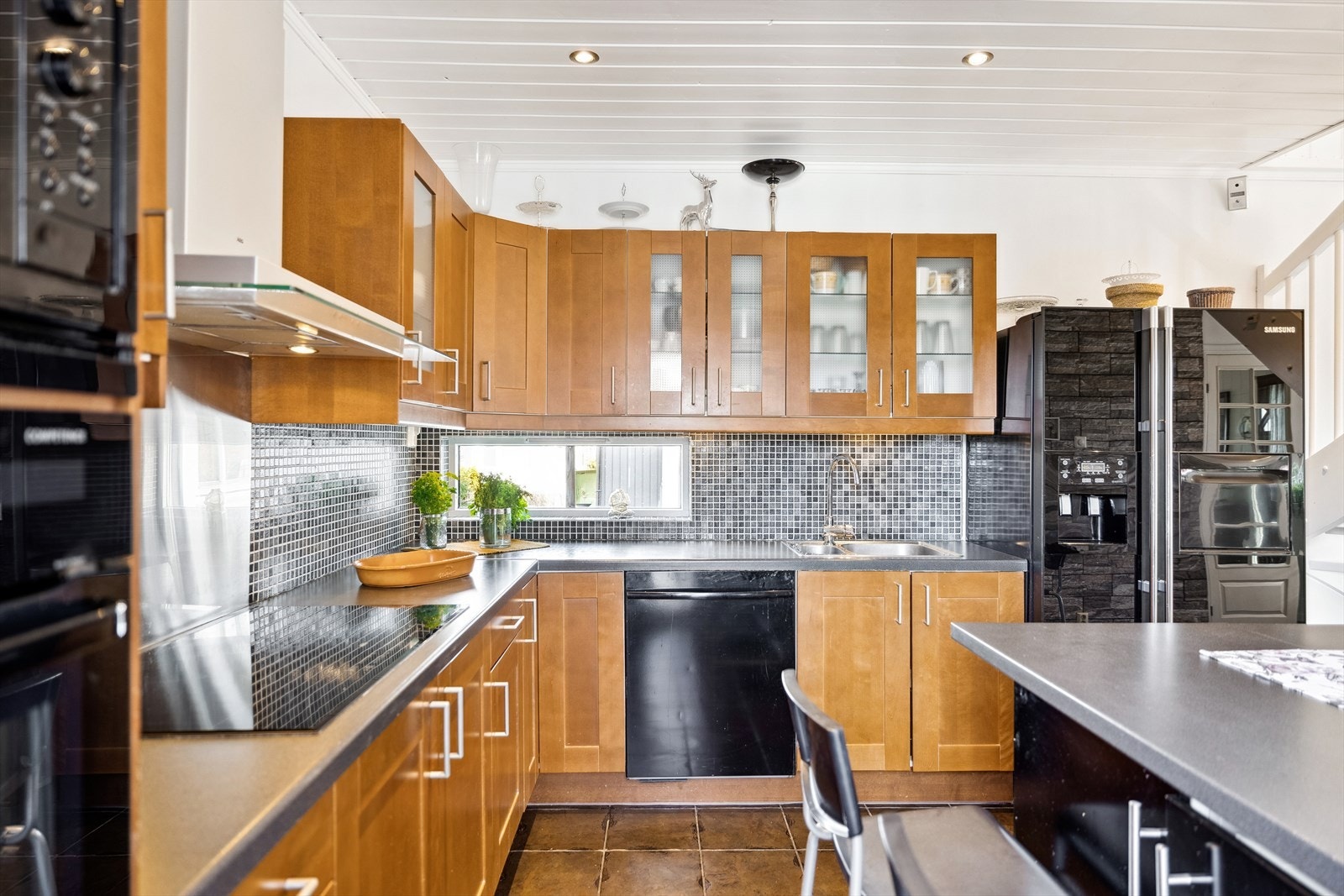 Kjøkkenet er oppført i en funksjonell L-form med god arbeidsflyt og skapplass. Galleribilde