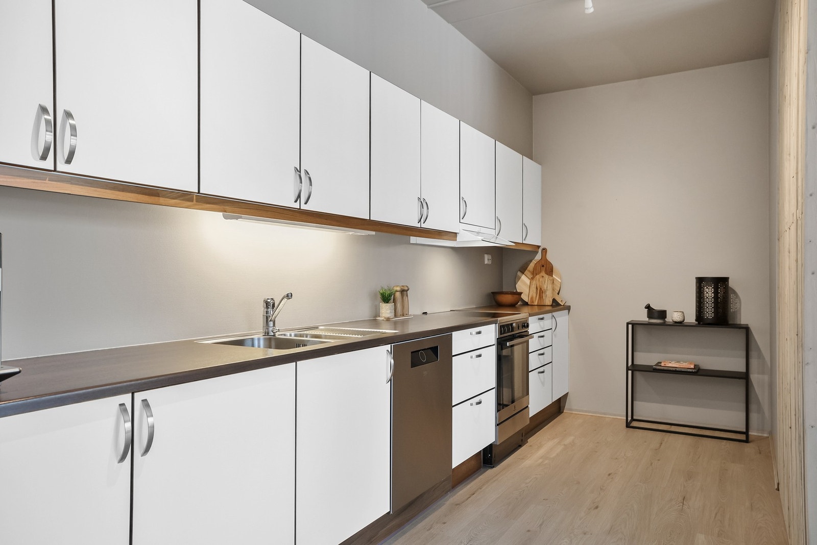 Kjøkkenet har en lys innredning med glatte fronter og benkeplate av laminat. Galleribilde