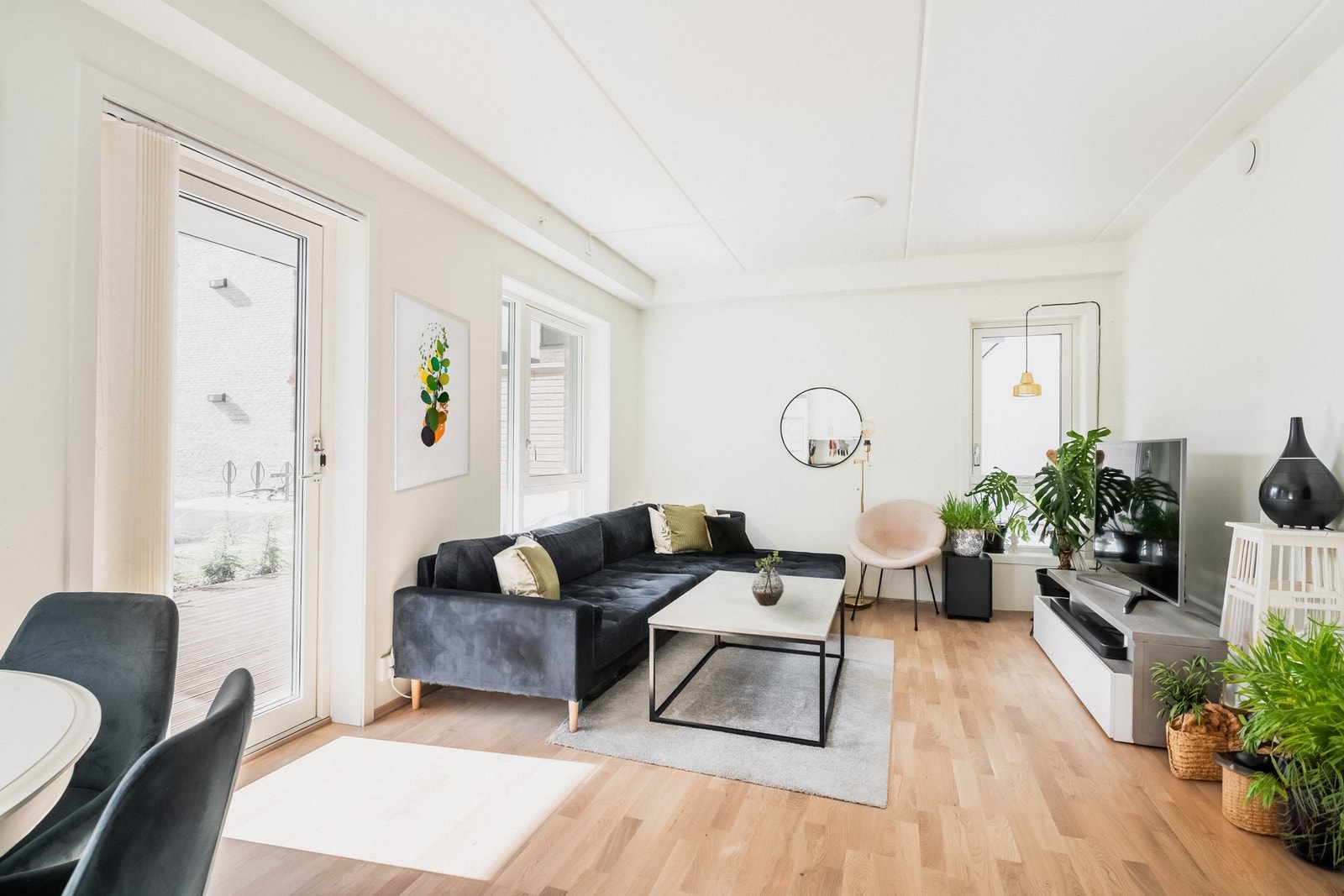 Stuen er stilren med hvitmalte overflater mot gyllent eikeparkettgulv. Galleribilde