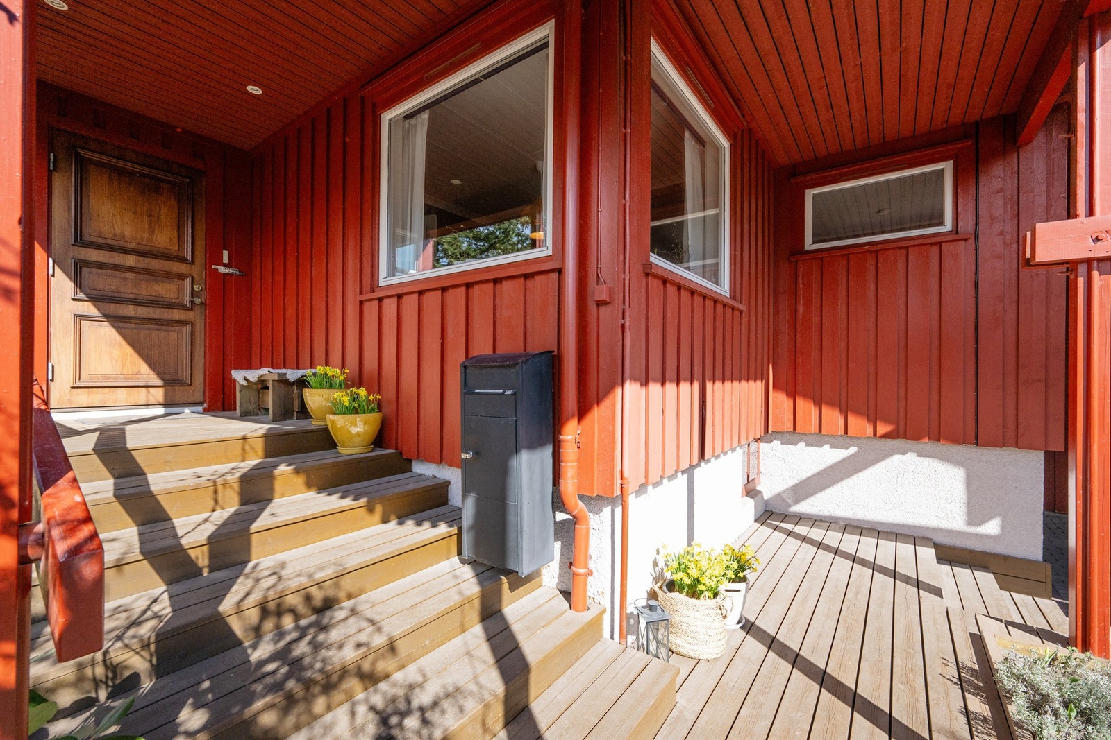 Overbygget inngangsparti med tørrskodd adkomst til den doble carporten med ladeboks Galleribilde