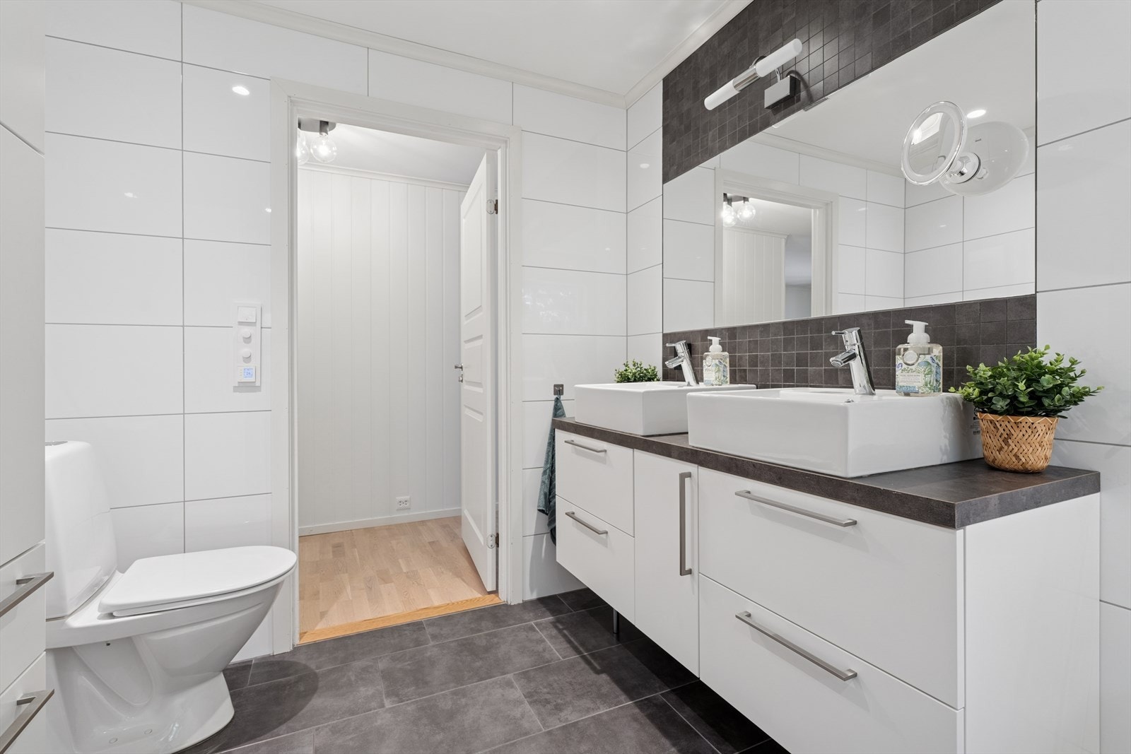 Baderommet er romslig, med tidløse fliser og varmekabler i gulvet. Galleribilde