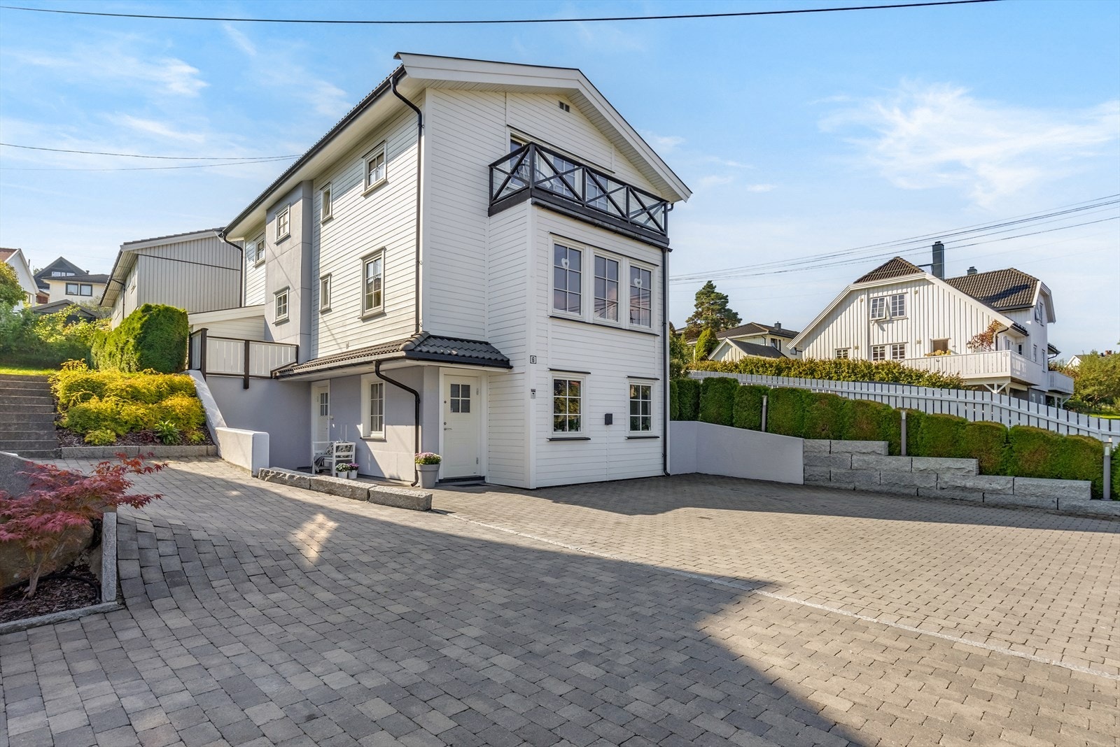 Det er god plass til flere biler på gårdsrommet. Eiendommen har en egen Zaptec ladeboks montert på husveggen, tilkoblet boligens strømnett. Galleribilde