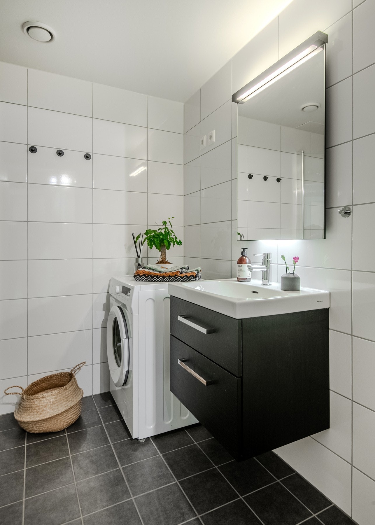 Badet er utstyrt med toalett, dusjhjørne med innfellbare glassdører, servantinnredning og opplegg for vaskemaskin. Her er det i tillegg muligheter og plass for etablering av vaskesøyle. Galleribilde