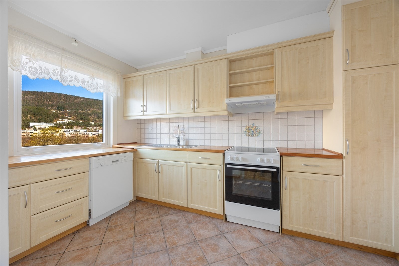 Hvitevarer som følger med i saget er oppvaskmaskin og komfyr. Fliser i skvettsone. Aquastopp i kjøkkeninnredning. Galleribilde