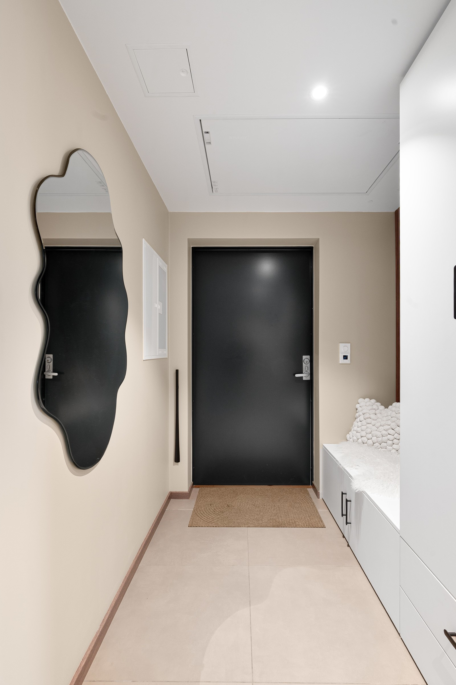 Velkommen inn. Flislagt entré med downlights i tak.
