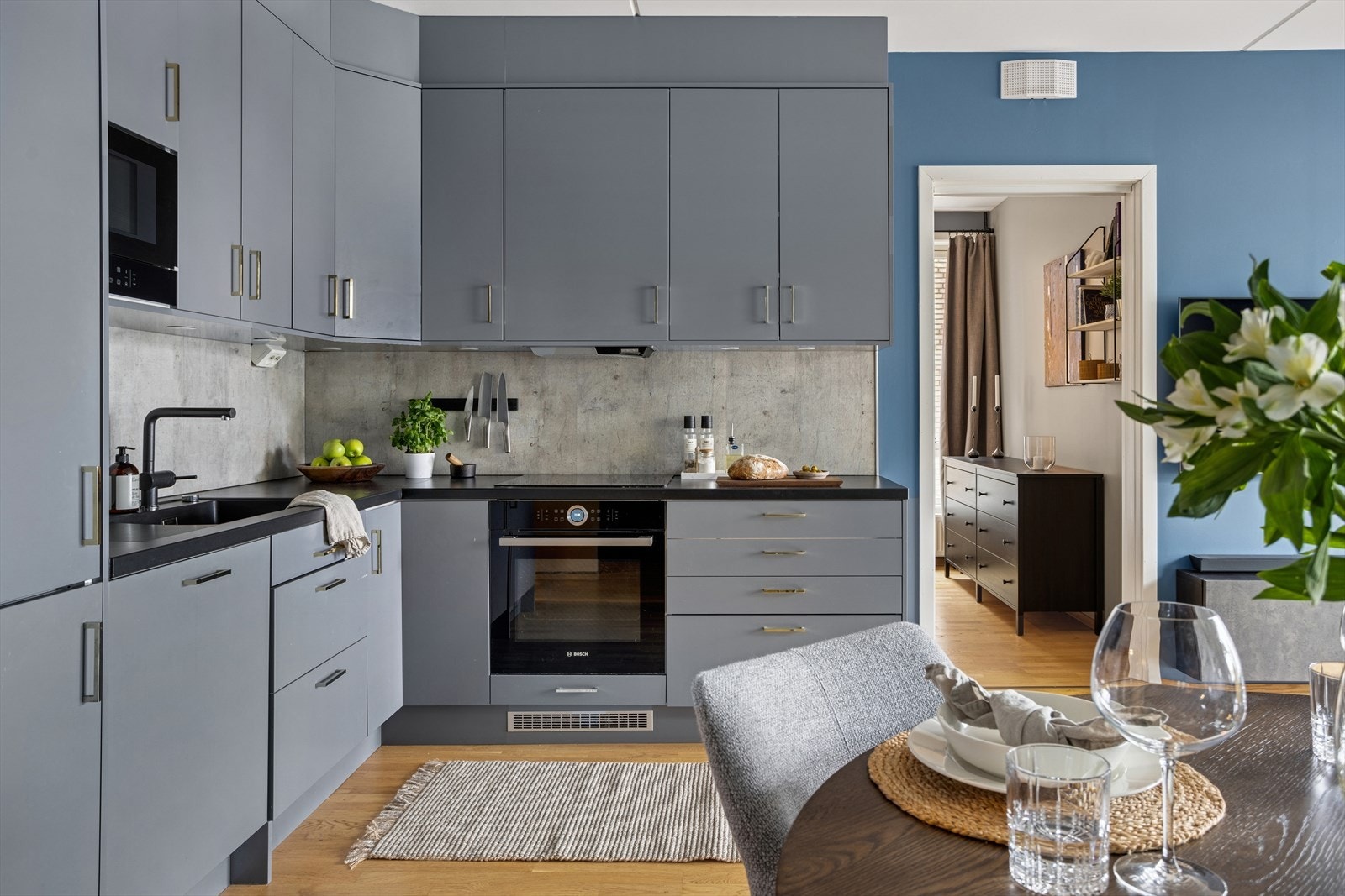 Kjøkkenet er moderne med slette overflater og sorte detaljer. Galleribilde