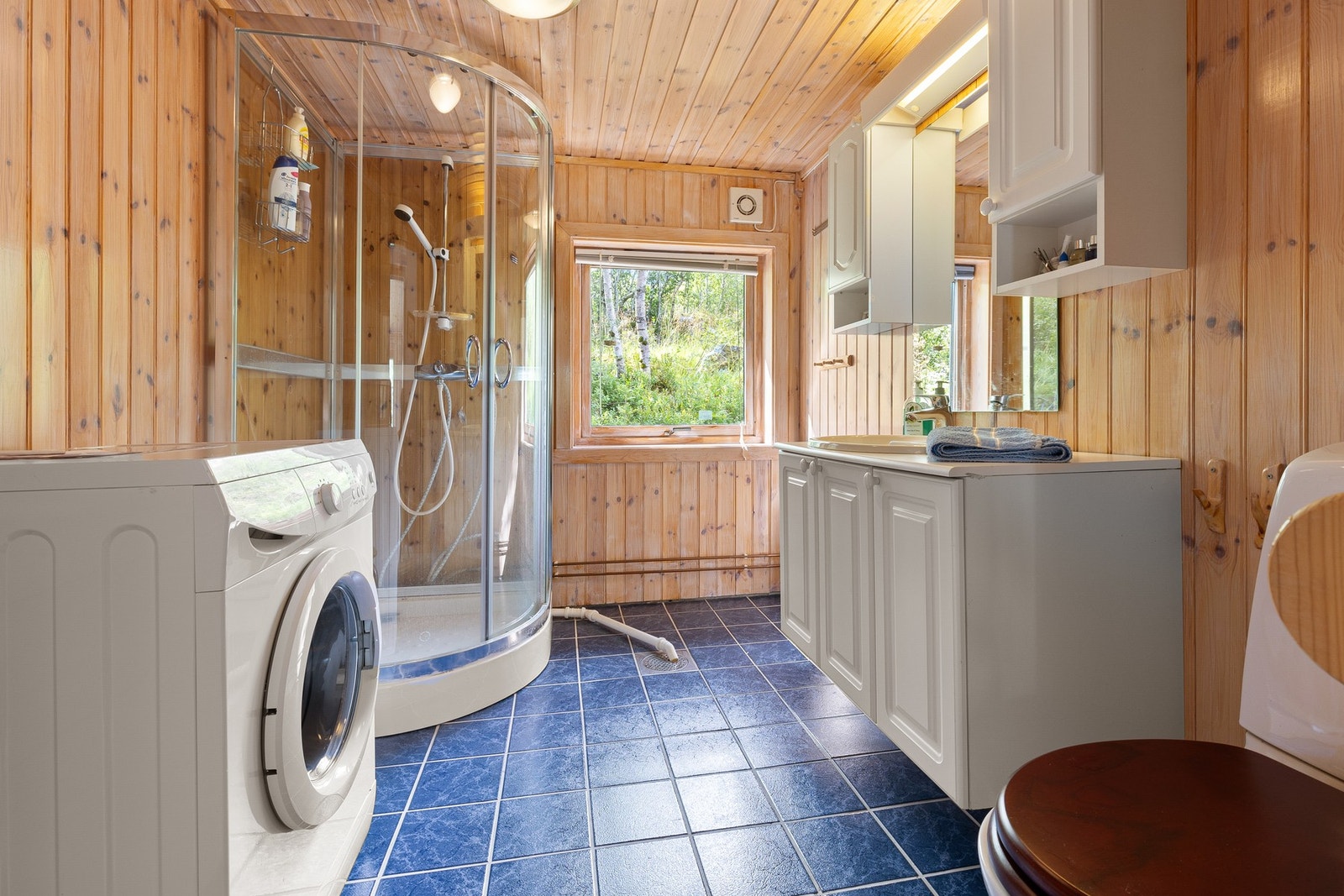 Toalettrom med fliser på gulv og panel på vegger. Rommet er ikke bygget som et våtrom. Galleribilde