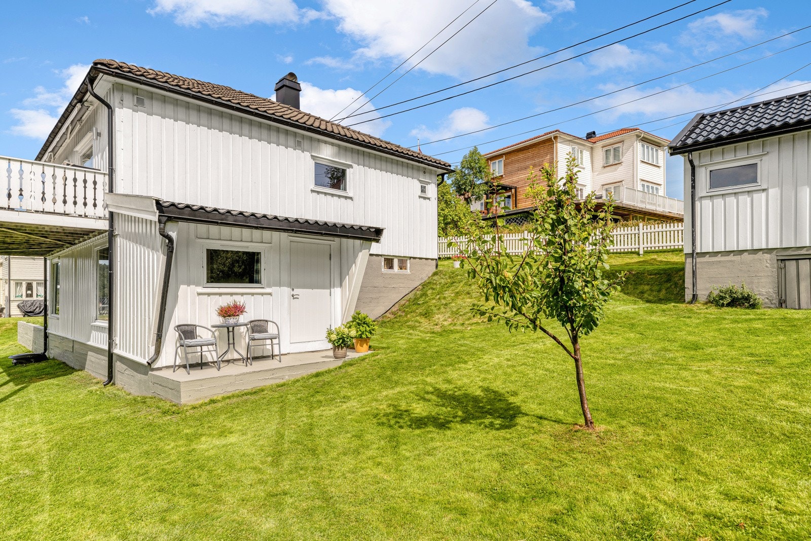 Tomten er stor og solrik, bebygd med enebolig over to plan, garasje og et uthus på 15 kvm. Galleribilde