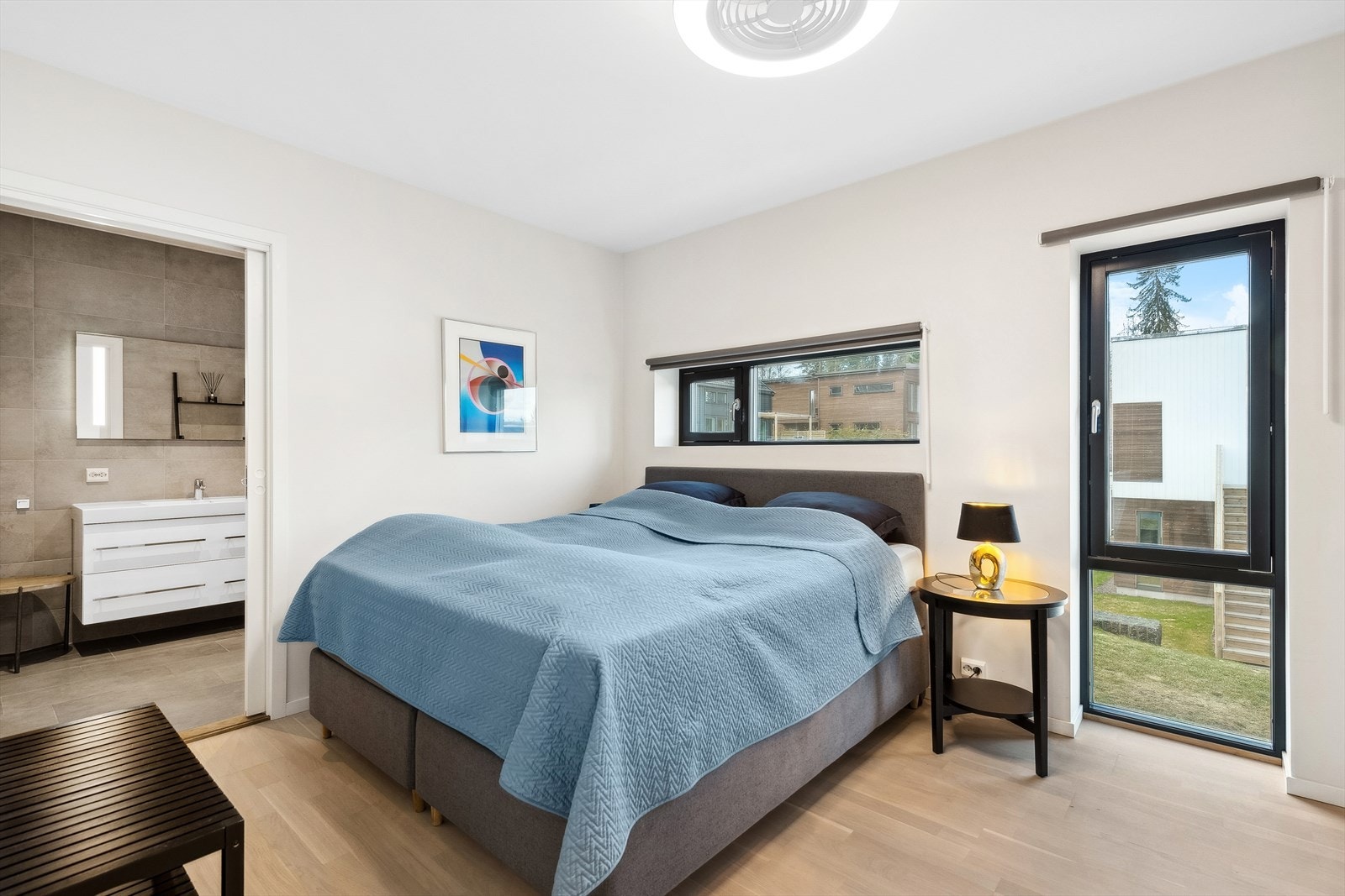 Lyst og luftig hovedsoverom med god plass til seng med tilhørende nattbord. Vifte og lys i taket på hovedsoverom styres via app som heter Mantra. Galleribilde