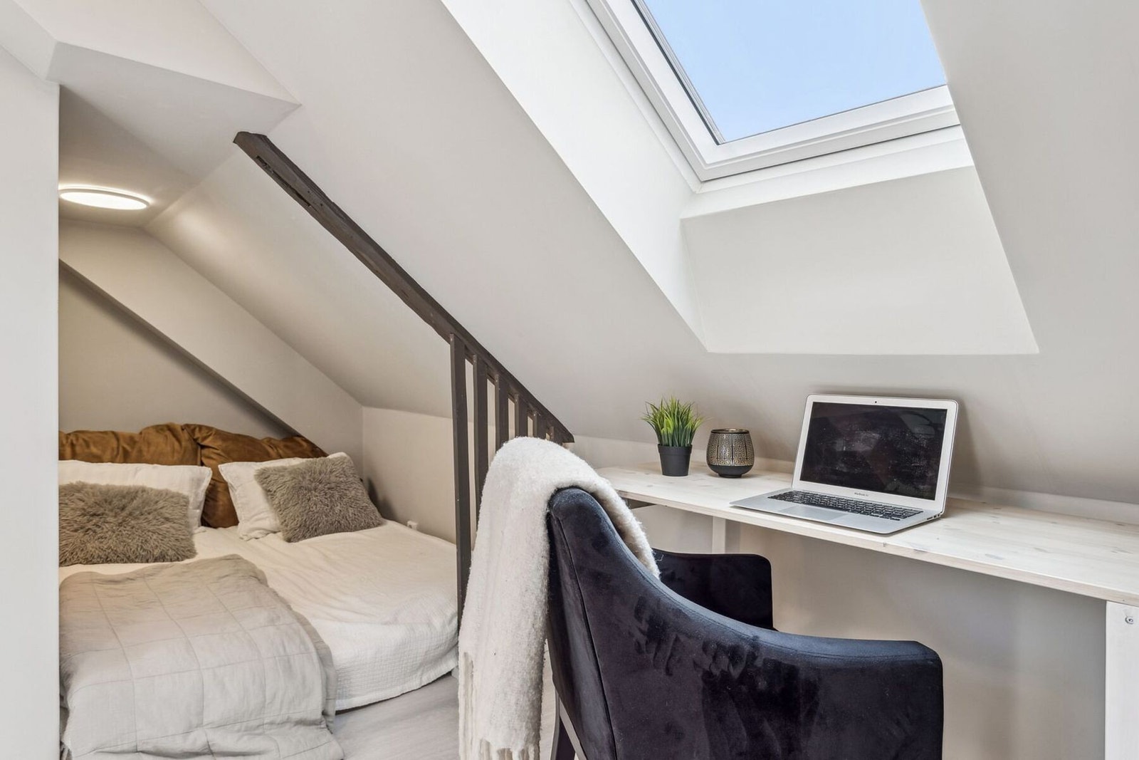 Romslig loft med stort soverom som har plass til seng, kontorløsning og sofa. Galleribilde