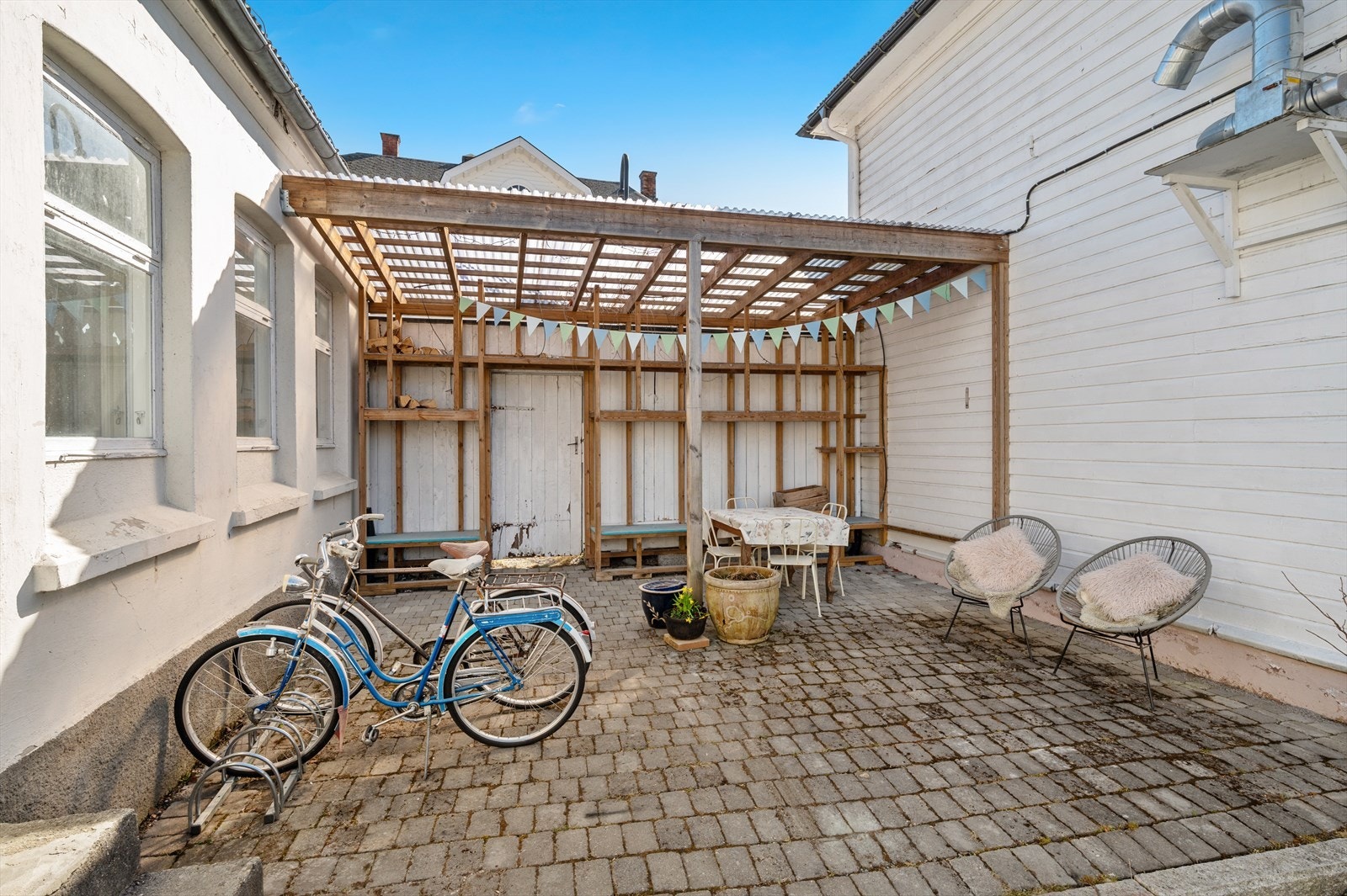 Intimt, skjermet og klart til bruk, bakgården er hjertet i dette lille universet. Galleribilde