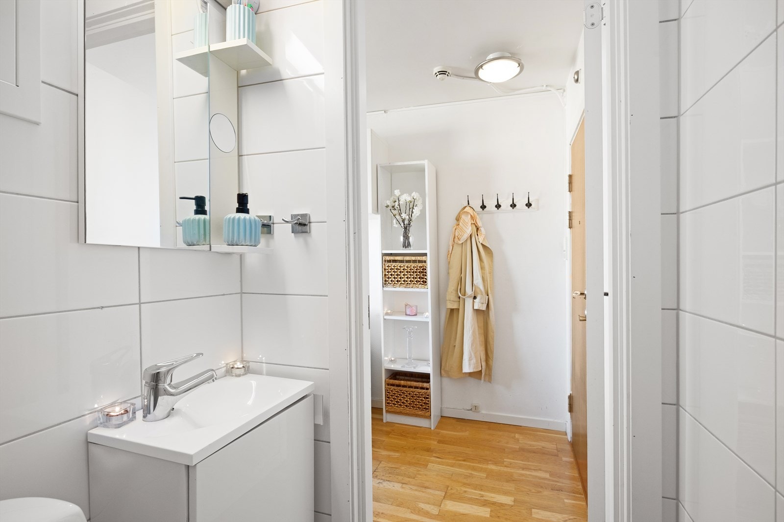 Badet er innredet med vegghengt toalett, dusjhjørne med glassvegger og servant med ettgreps blandebatteri integrert i stilren baderomsinnredning. Galleribilde