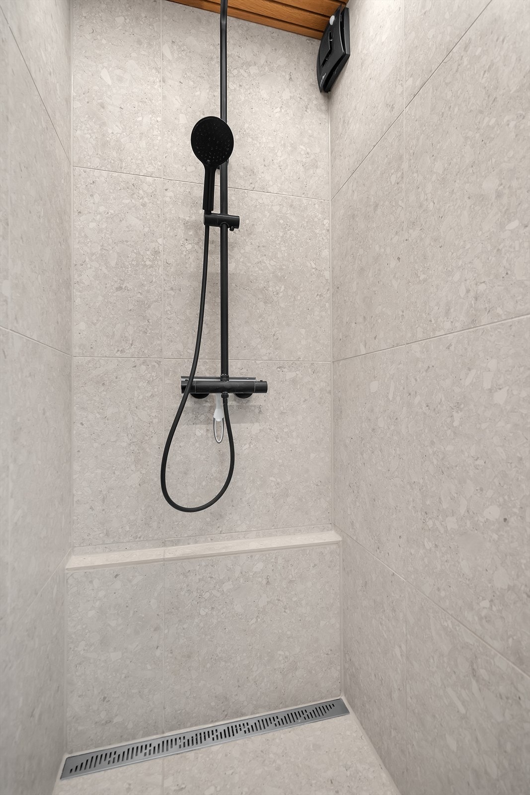 Pent bad med gulvvarme. Badet er innredet med fliser med varme, fliser på vegg og spiler i taket. Galleribilde