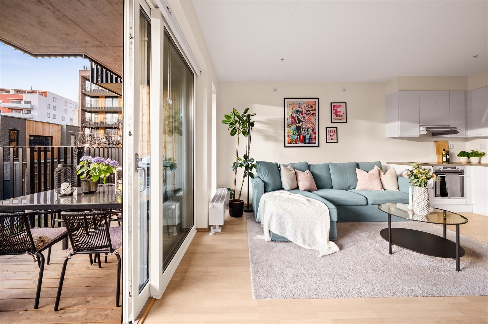 Stor skyvedør skaper åpen følelse mellom stue og balkong. Galleribilde