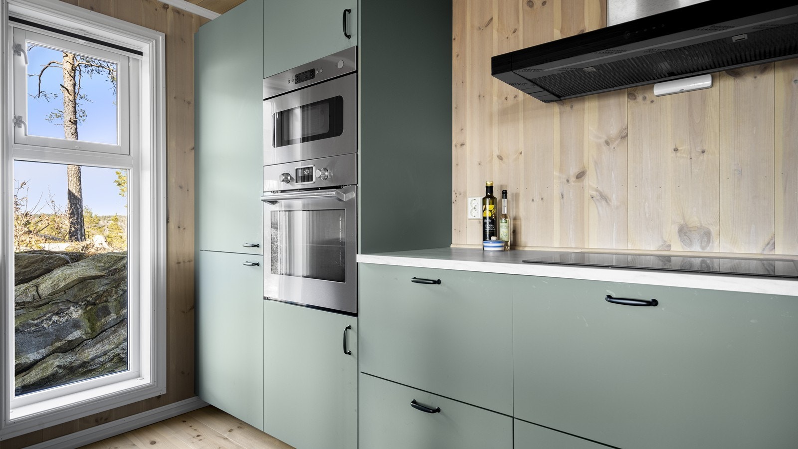 Integrerte hvitevarer følger hytta ved salg. Legg merke til det fine eksponerte fjellet gjennom vinduet Galleribilde