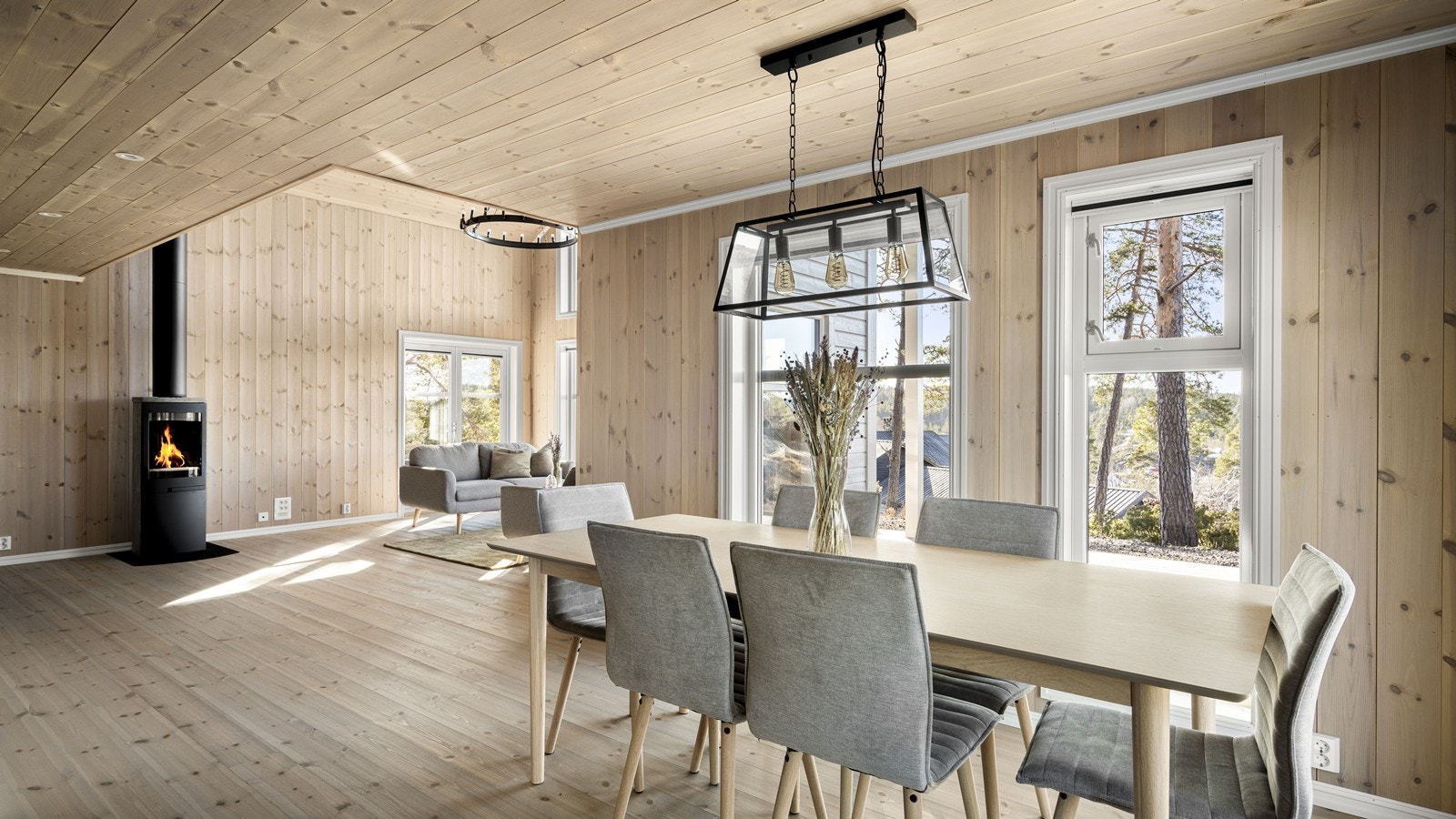 Fin og stemningsskapende peisovn med hyggelig plassering i stuen Galleribilde