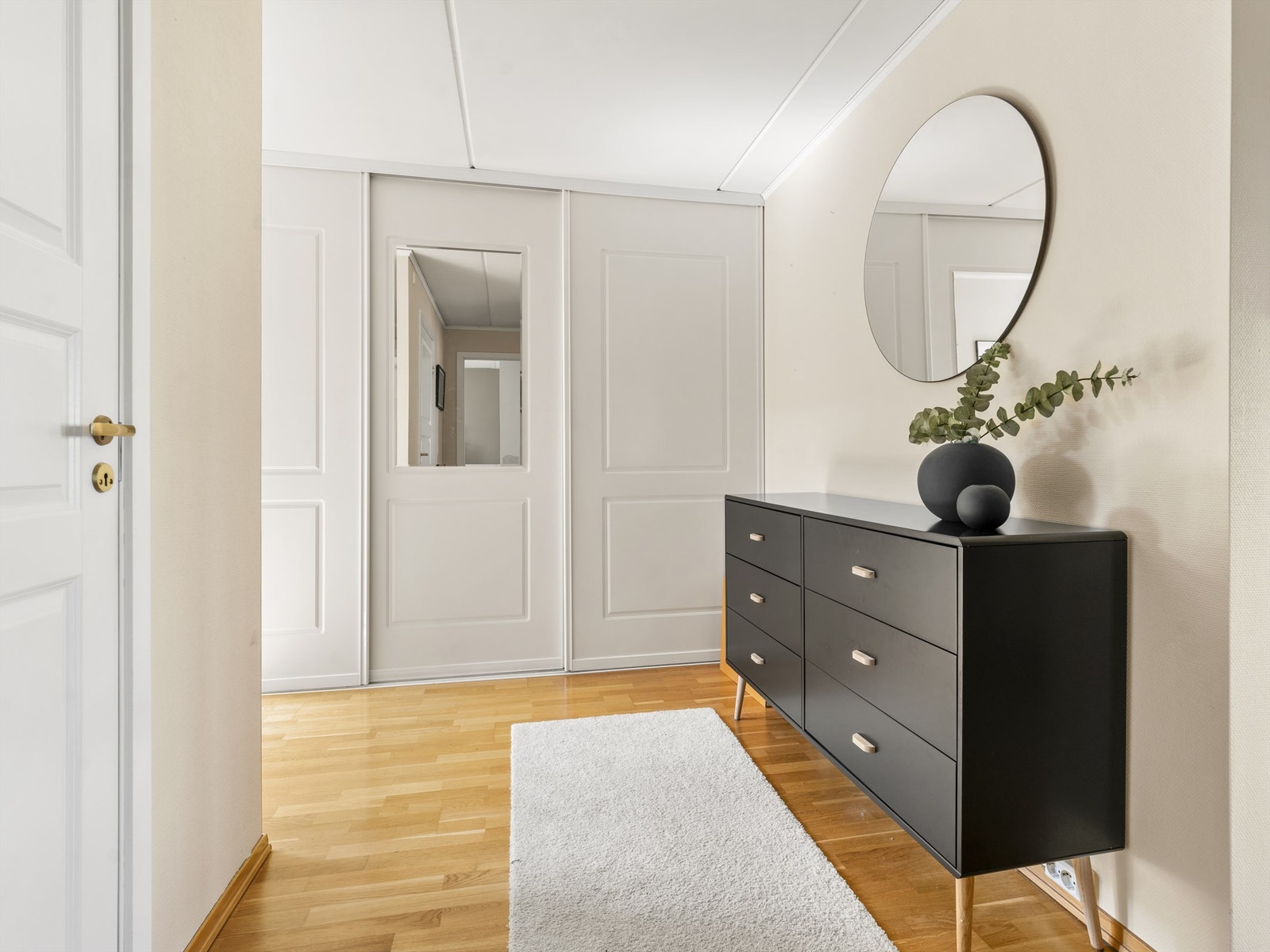 Entreens skyvedørsgarderobe oppbevarer sko og yttertøy lett tilgjengelig like innenfor inngangsdøren. Galleribilde