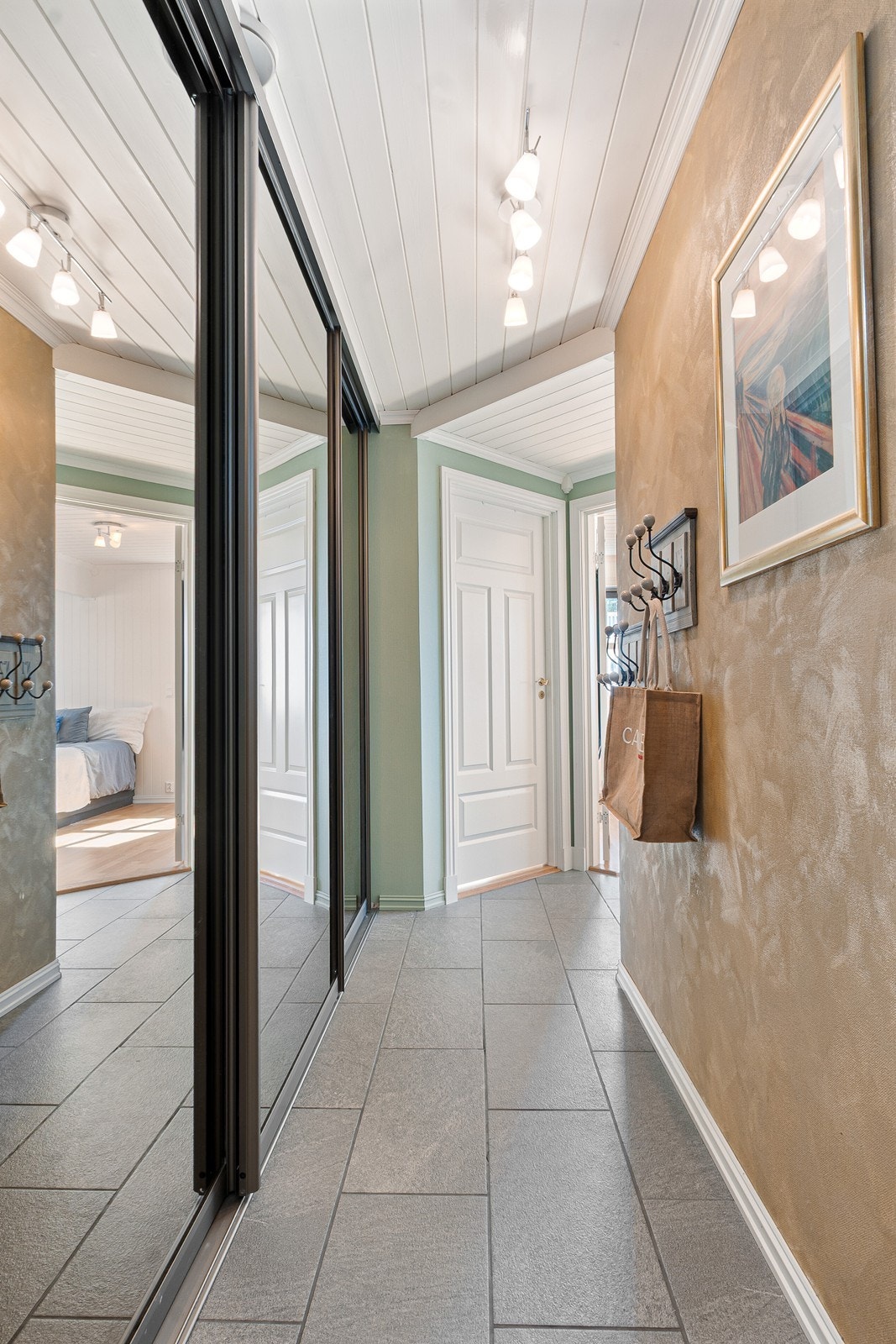Gang med stor skyvedørsgarderobe gir enkel orden i ytterklær, tilbehør og sko. Galleribilde
