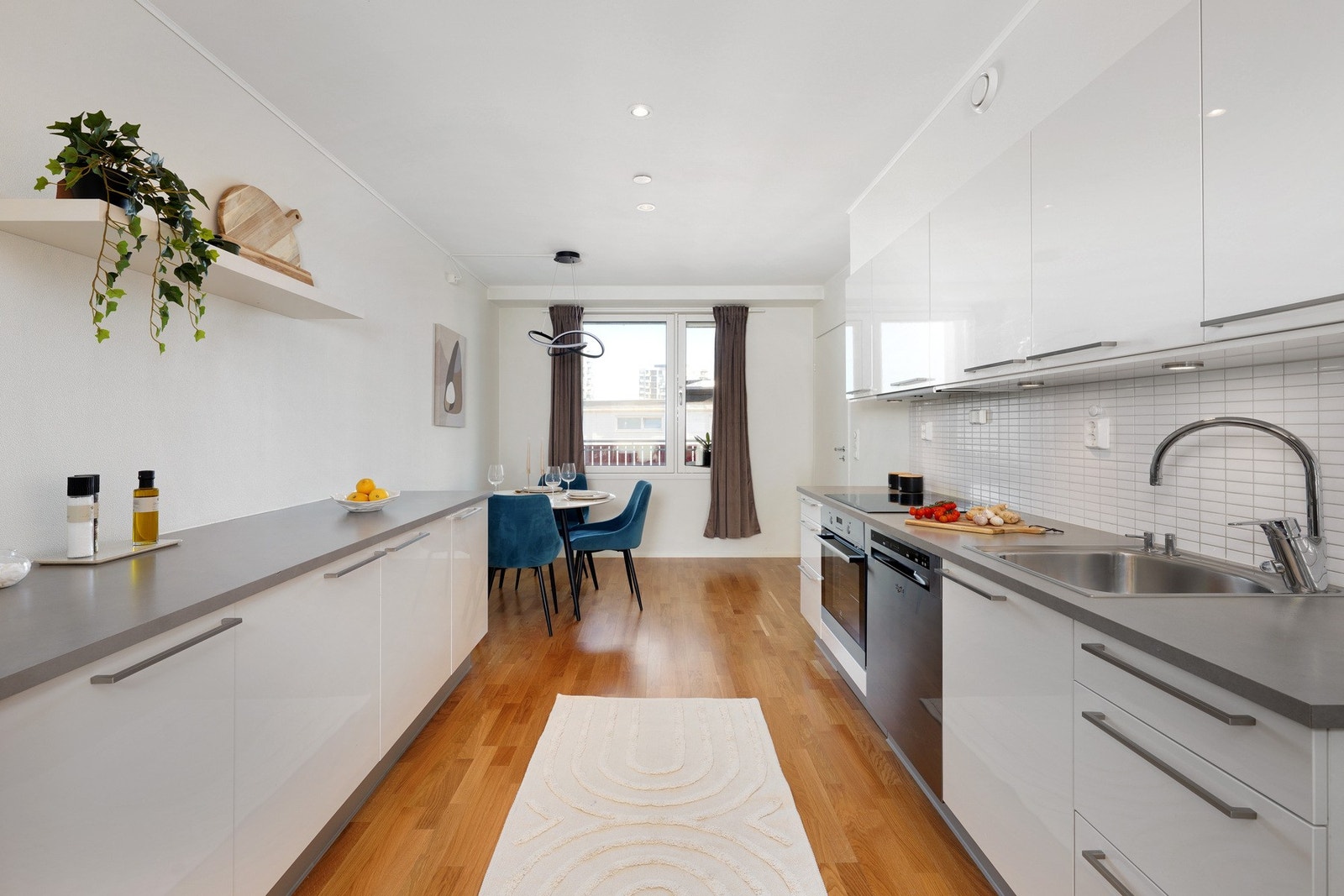 Lyst lekkert kjøkken byr på rikelig med skap- og benkeplass Galleribilde