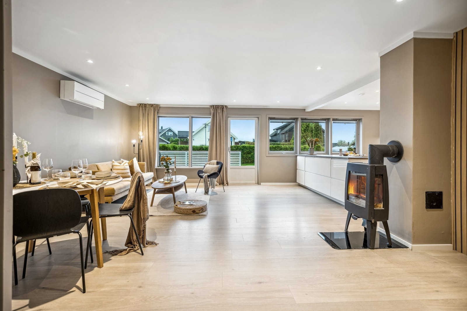 Boligen har en åpen stue-/kjøkken løsning som er et sosialt og lyst allrom for hele familien Galleribilde