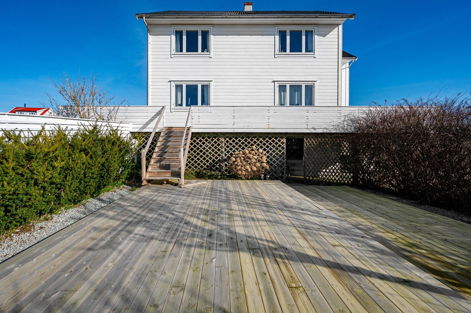Tomten er opparbeidet med stort terrassedekke. Galleribilde