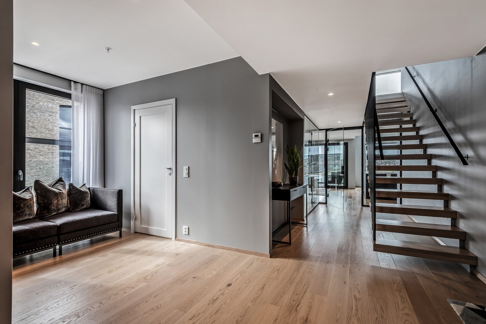 Det etableres en rolig stemning allerede ved inngangspartiet, hvor øyet dras mot de store vinduene og fjordutsikten i oppholdsrommet. Galleribilde