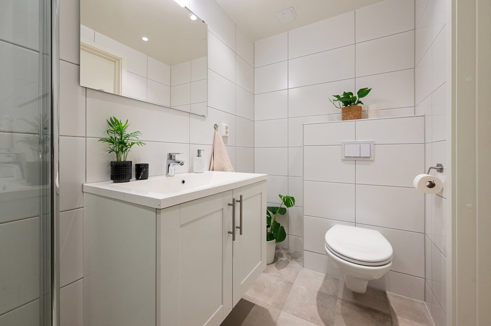 Innredningen består av vegghengt toalett og servantinnredning, ovenpåliggende servant og dusjhjørne. Galleribilde