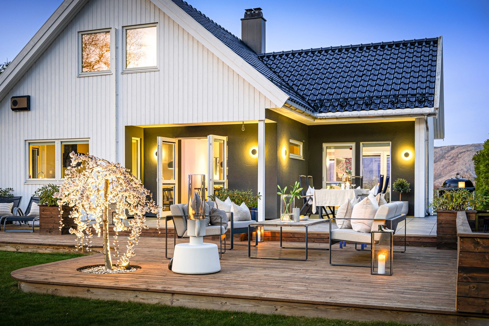 Langs markterrassen er det en lang, plassbygd blomsterkasse, og på to steder er det plantet japansk kirsebærtre, samt montert flott belysning under. Galleribilde