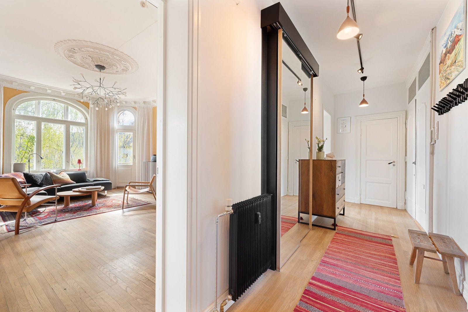 Klassisk gang med praktisk skoskap bak speilskyvedøren. Gjestetoalett rett frem. Doble inngangsdører til høyre i bildet. Galleribilde