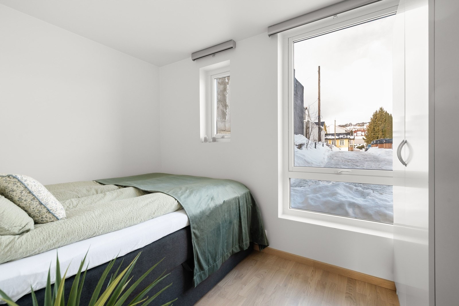 Lyst soverom med plass til dobbeltseng og garderobe Galleribilde