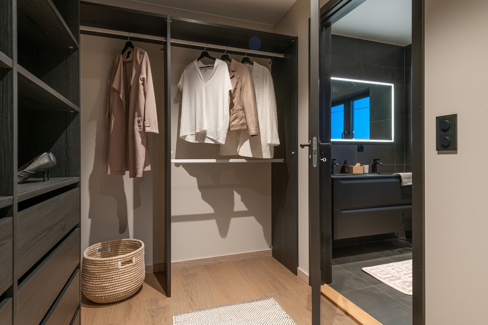 Detaljbilde av walk-in garderobe inn mot tilhørende en-suite baderom. Galleribilde