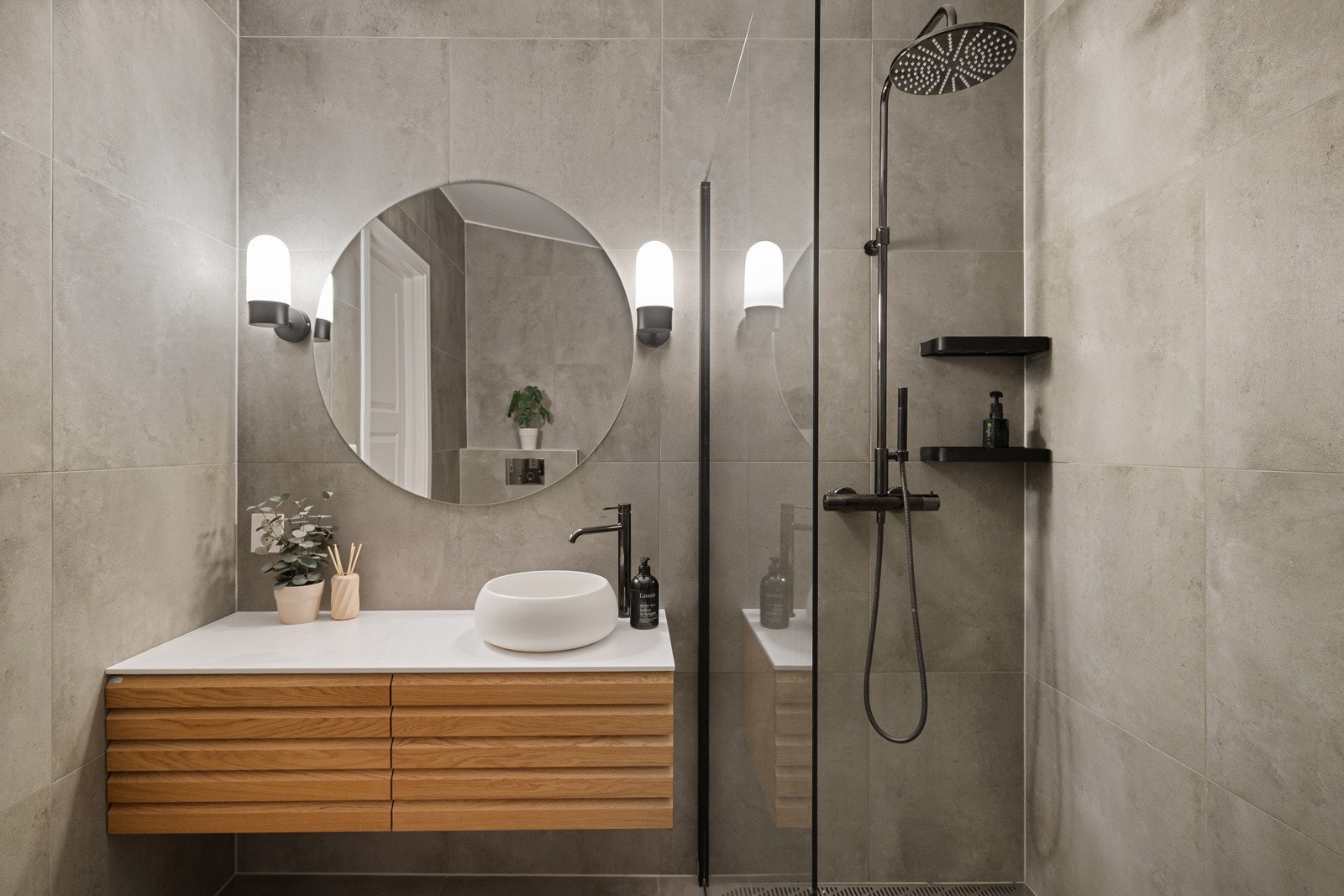 Innredning med servant, veggmontert toalett og dusjhjørne med glassvegg Galleribilde