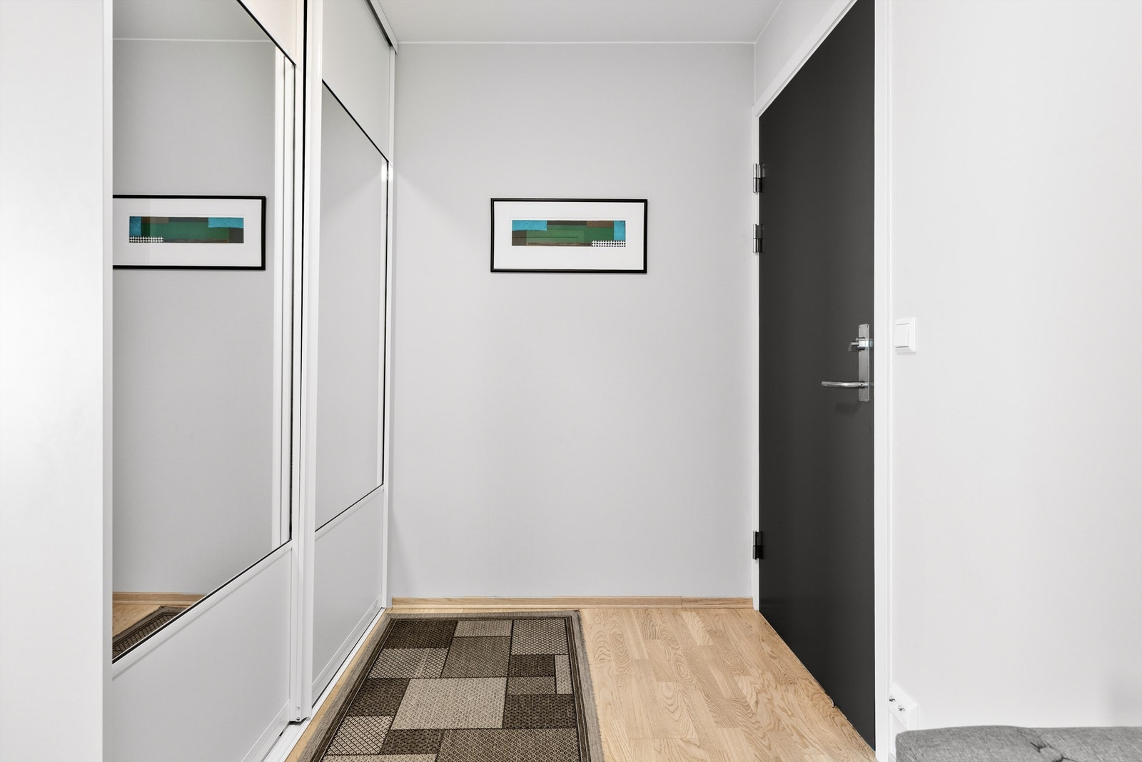 Romslig inngangsparti med stor skyvedørsgarderobe med plass til å henge fra seg yttertøy og sko. Galleribilde