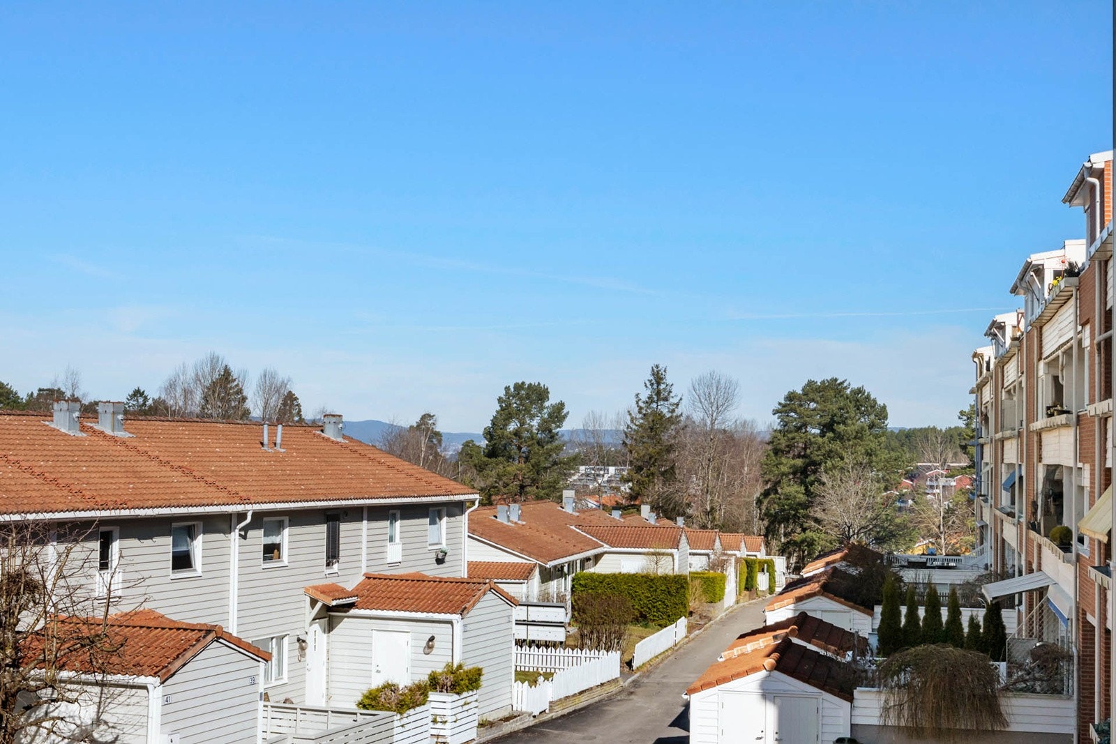 Vestvendt balkong med hyggelig vidt utsyn mot skogholt og rekkehusbebyggelse. Meget gode solforhold gjør at sommerdagene kan nytes til det fulle. Fra balkongen har du utsikt til flotte solnedganger! Galleribilde
