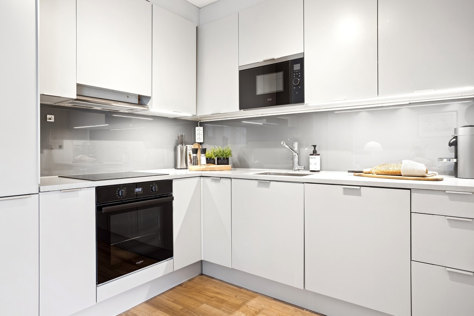 Kjøkkenet har integrerte hvitevarer som kjøleskap, stekeovn, oppvaskmaskin og mikrobølgeovn Galleribilde