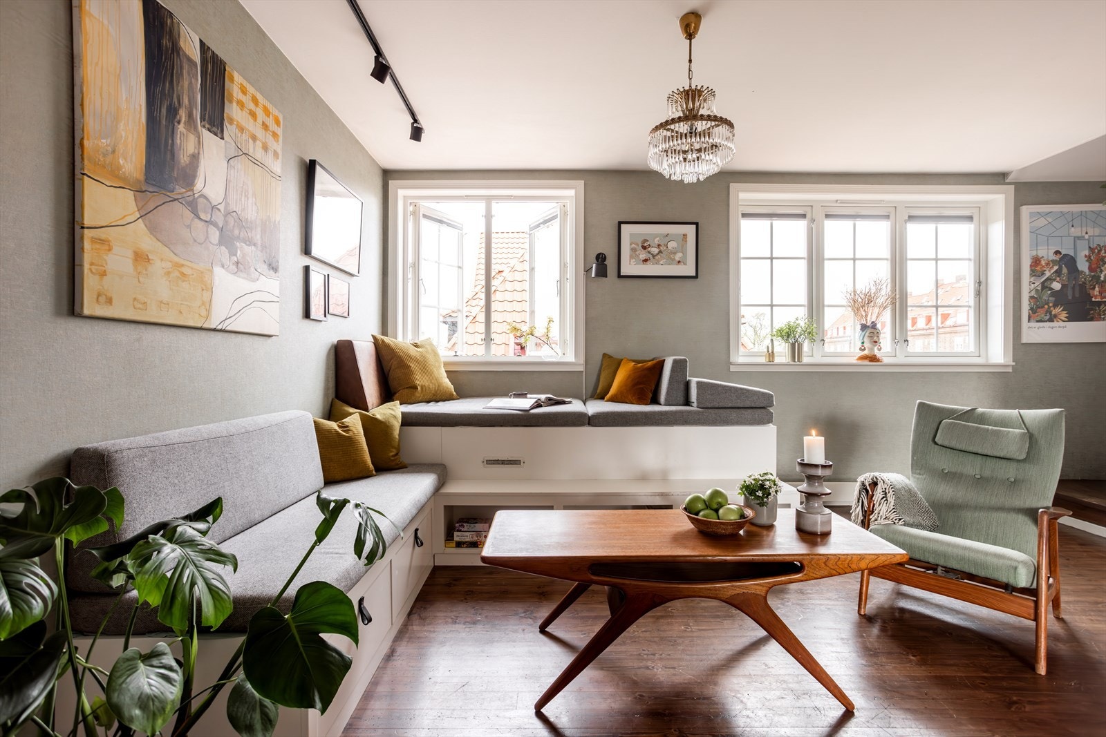 Stuen har en plassbygget sofa som er bygget av møbelsnekker. Putene er sydd av møbeltapetseter. Galleribilde