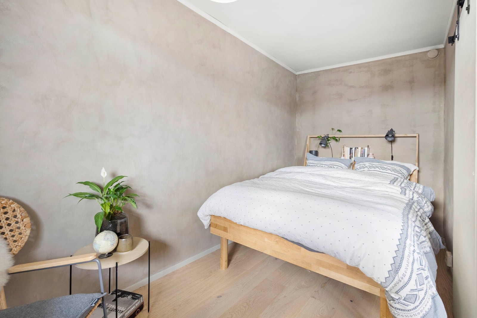 Leiligheten har et lekkert soverom med kalkmalte vegger og parkettgulv fra 2021. Galleribilde