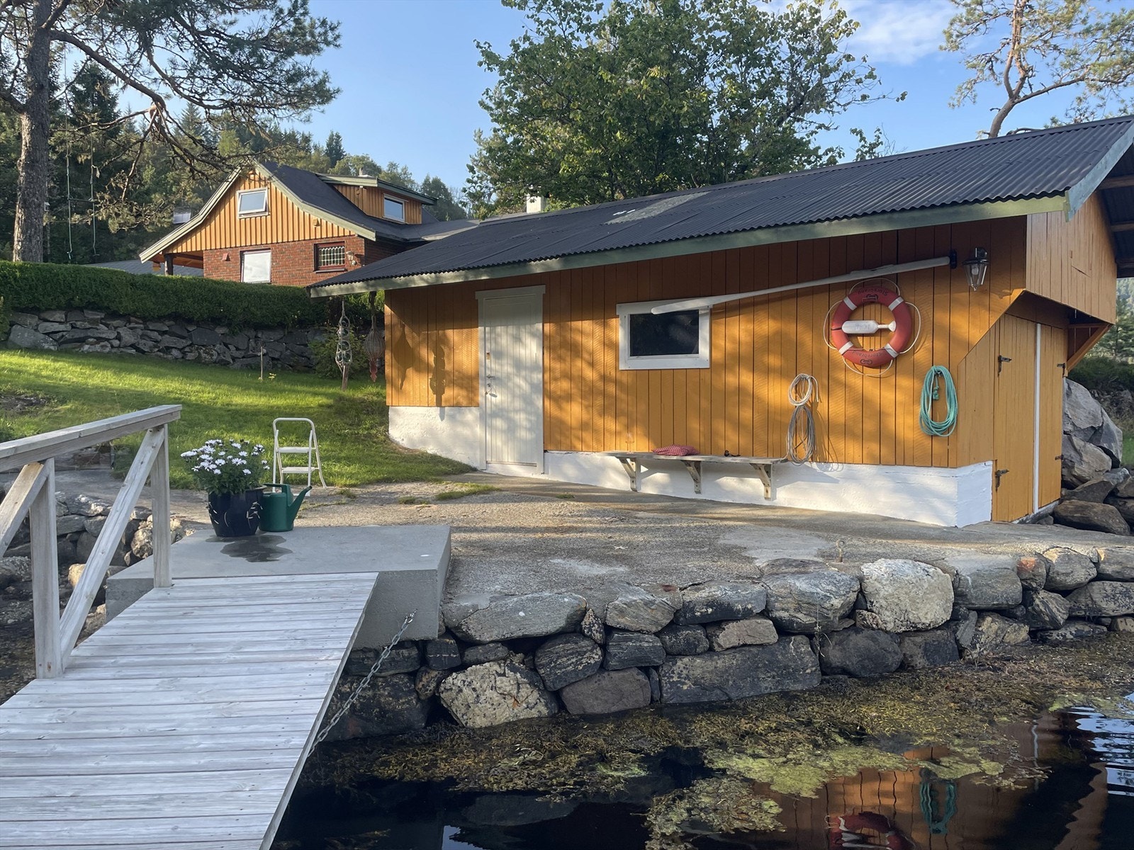 Naust ved sjøen med flytebrytte Galleribilde