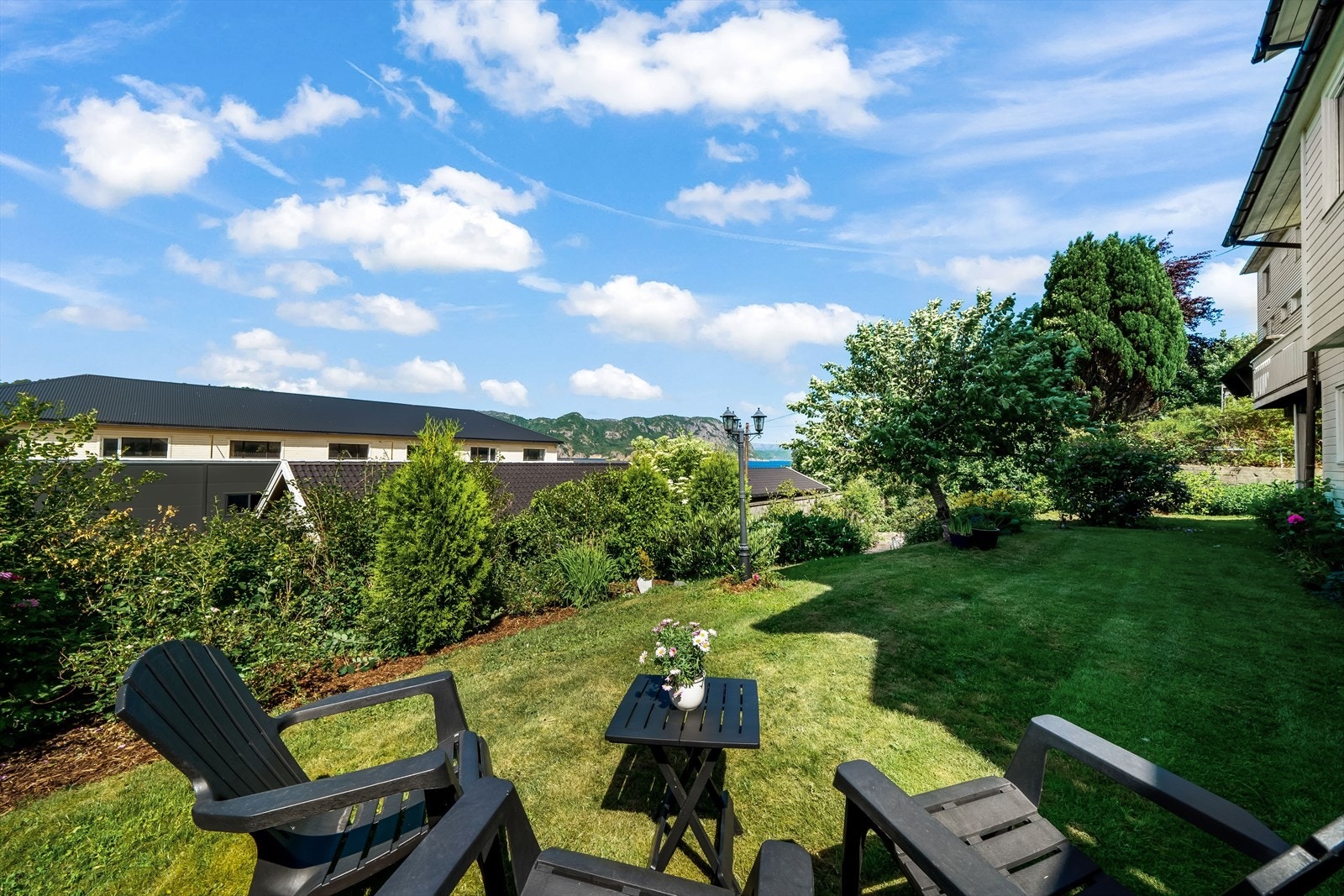 Usjenert hage i front av boligen som er pent opparbeidet og beplantet. Galleribilde