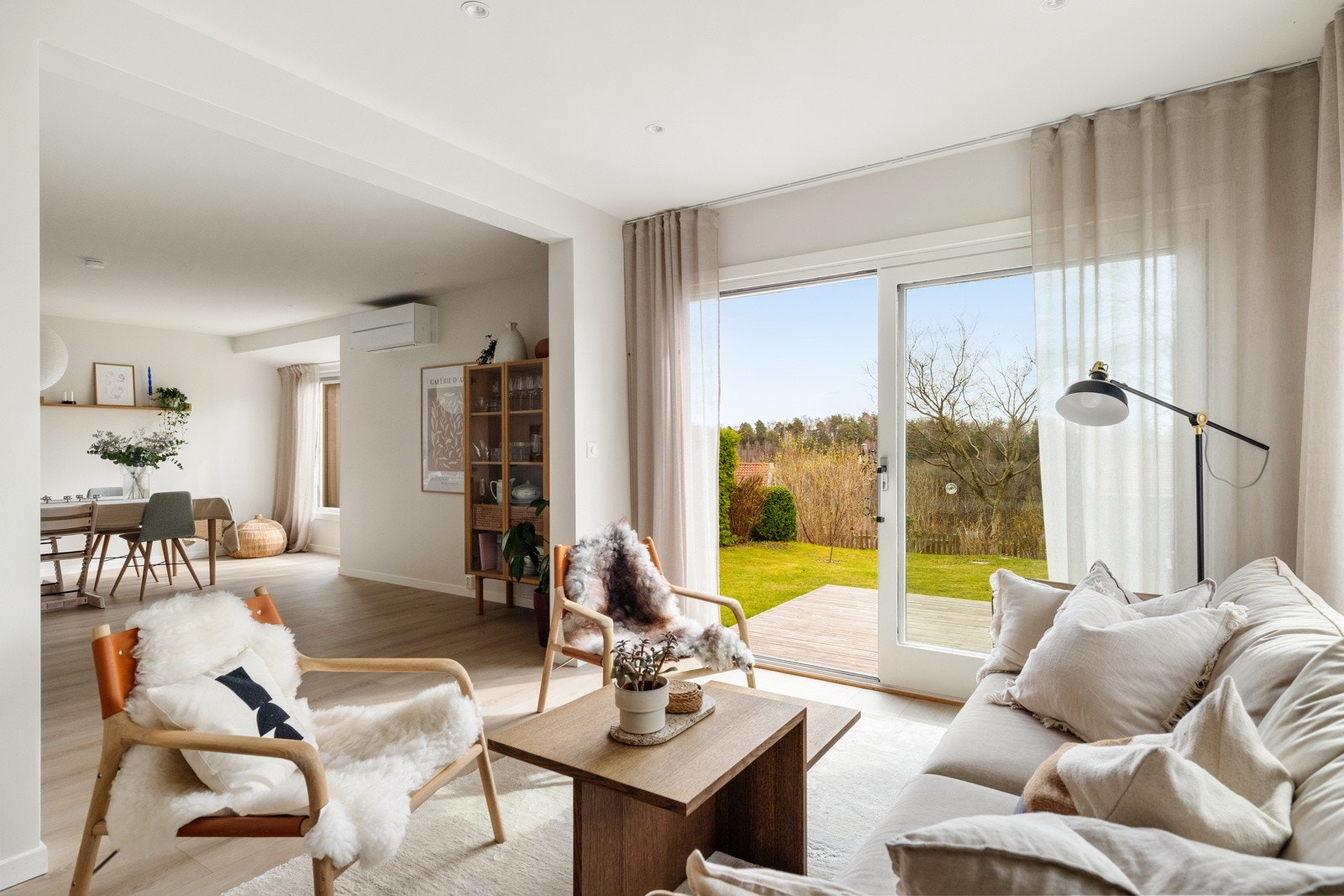 Store vindusflater slipper inn rikelig med naturlig dagslys. Fra stuen er det direkte utgang til en solrik terrasse og hage med utekjøkken. Galleribilde
