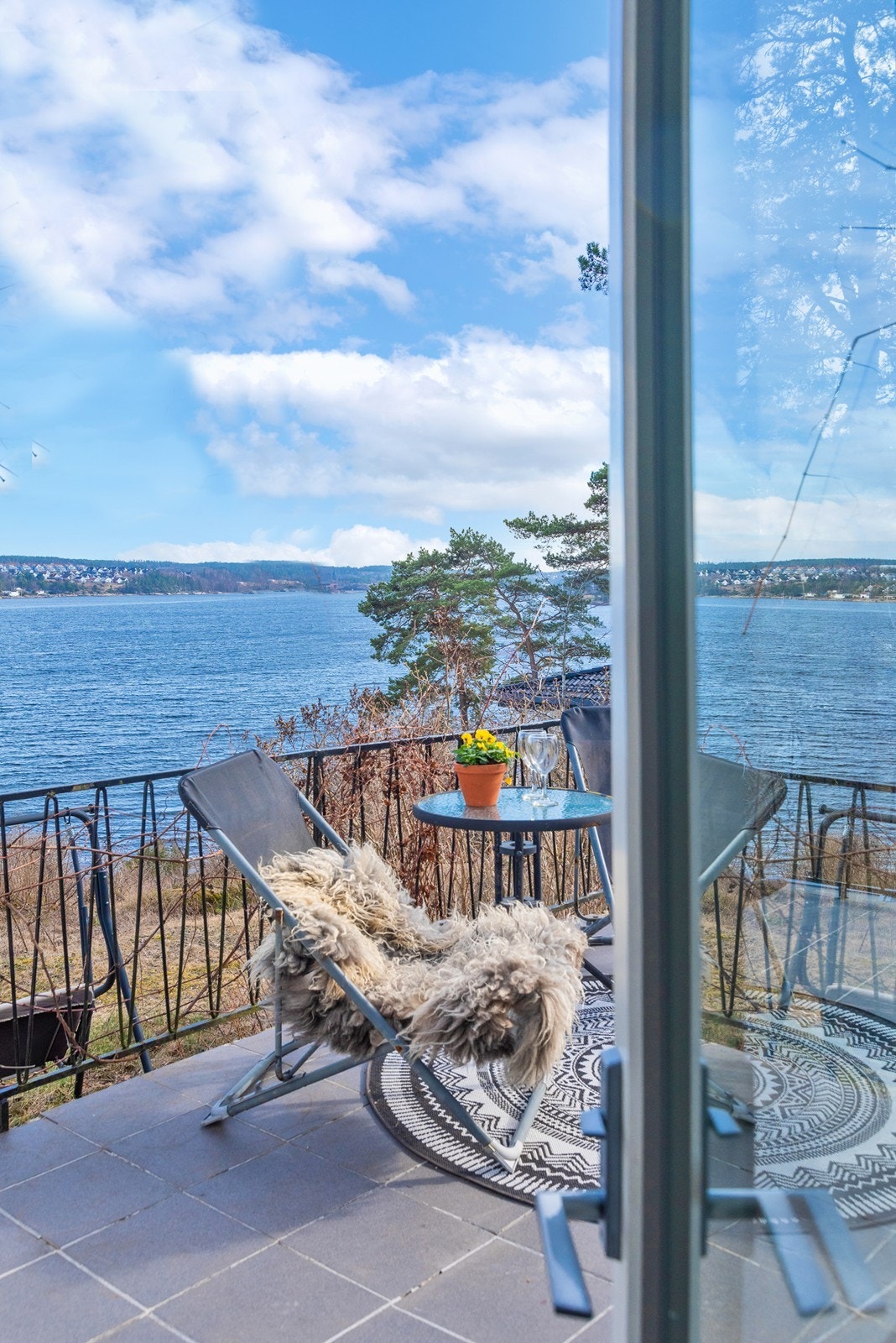 Veranda har flislagt gulv og rekkverk i smijern. Ta enkelt med måltidene ut og nyt de i idylliske omgivelser. Galleribilde