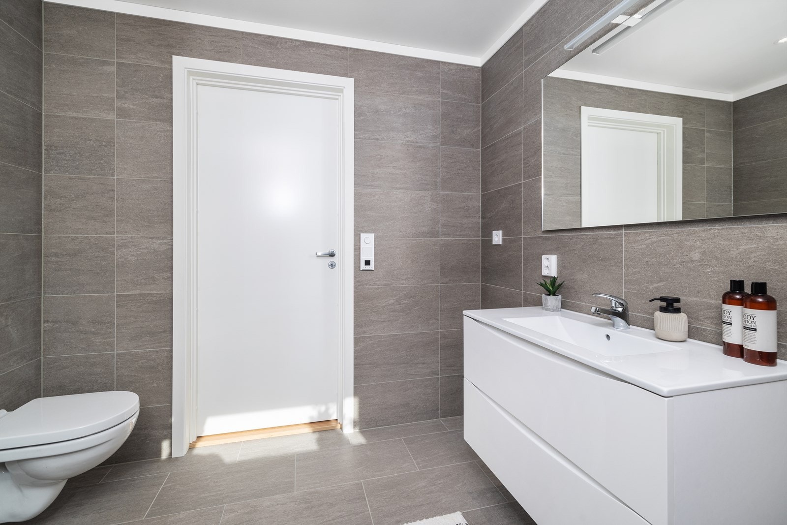 Badet er innredet med servant, dusjhjørne og toalett. Galleribilde