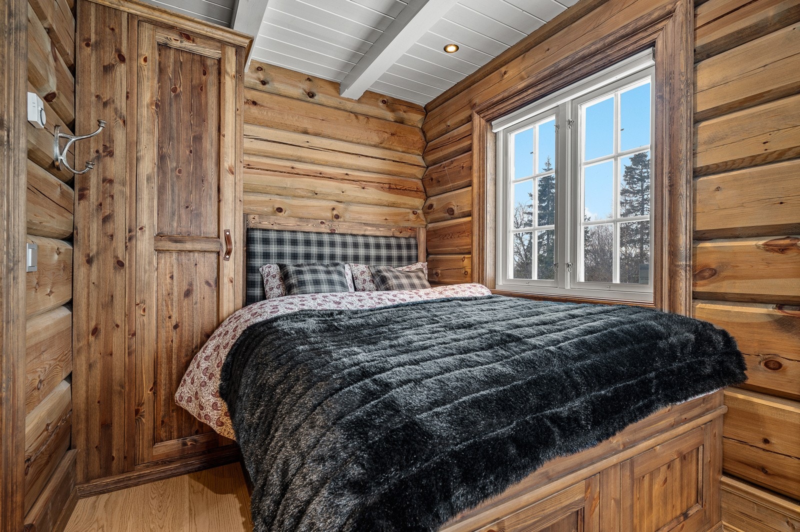 Soverom II ligger i hyttas 1.etasje og er innredet med plassbygget dobbeltseng med skuffer og garderobeskap Galleribilde